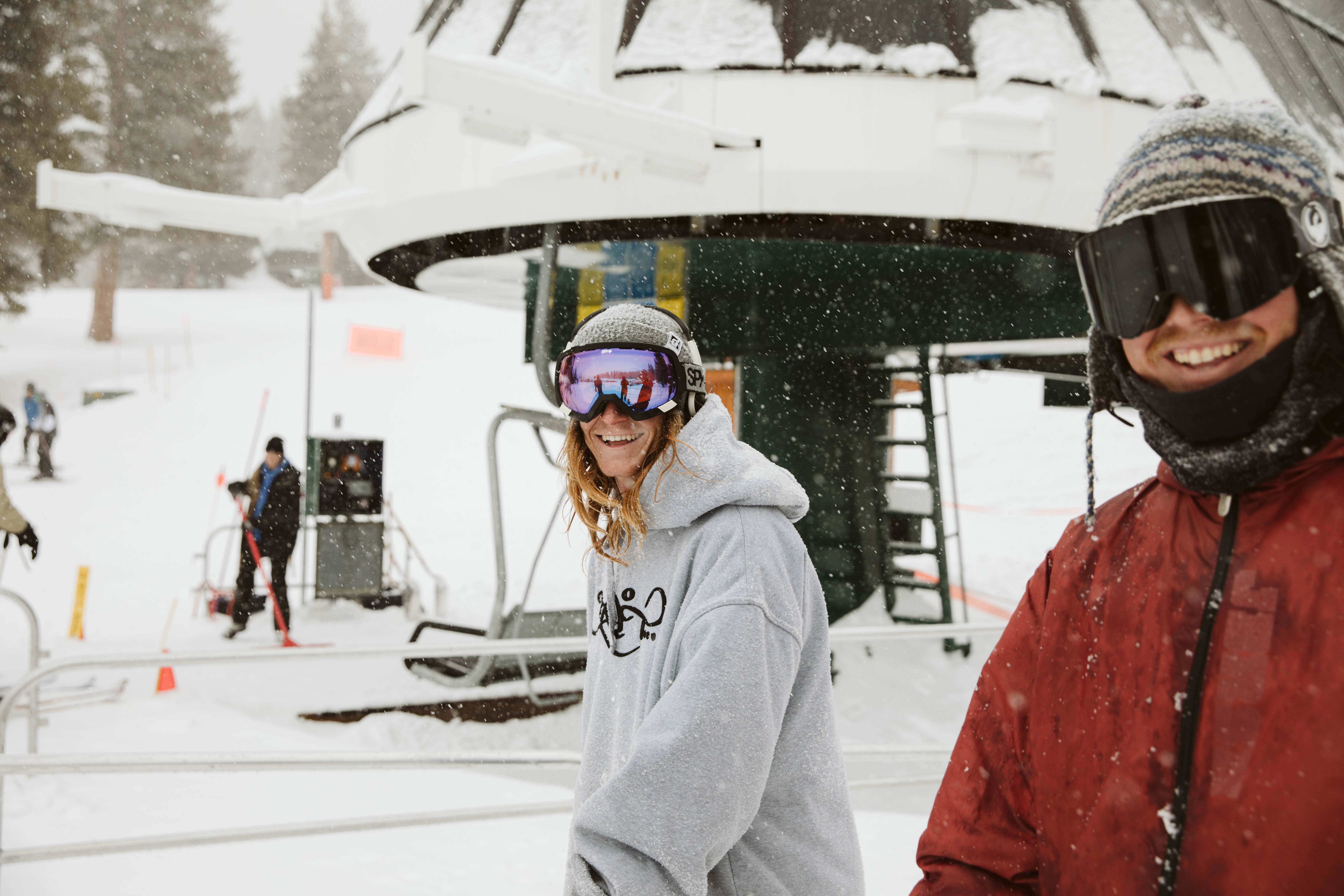 Two guys smiling on a ski slope.