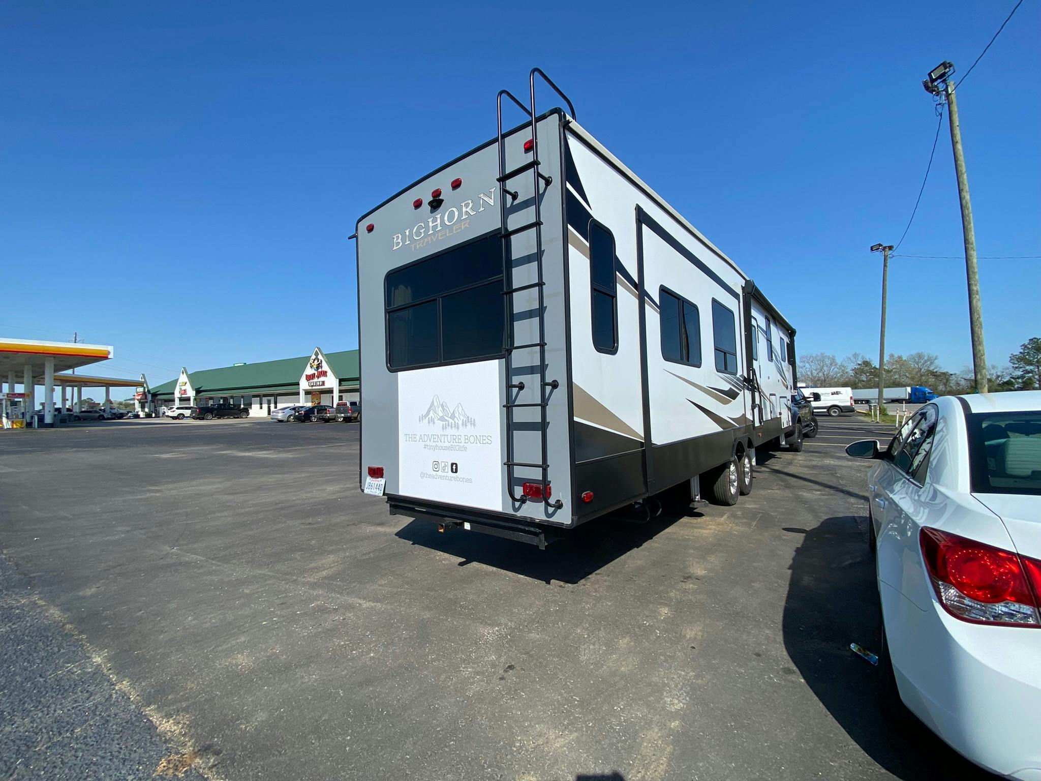 DARREN & AMANDA BONE's rv in a gas station parking lot