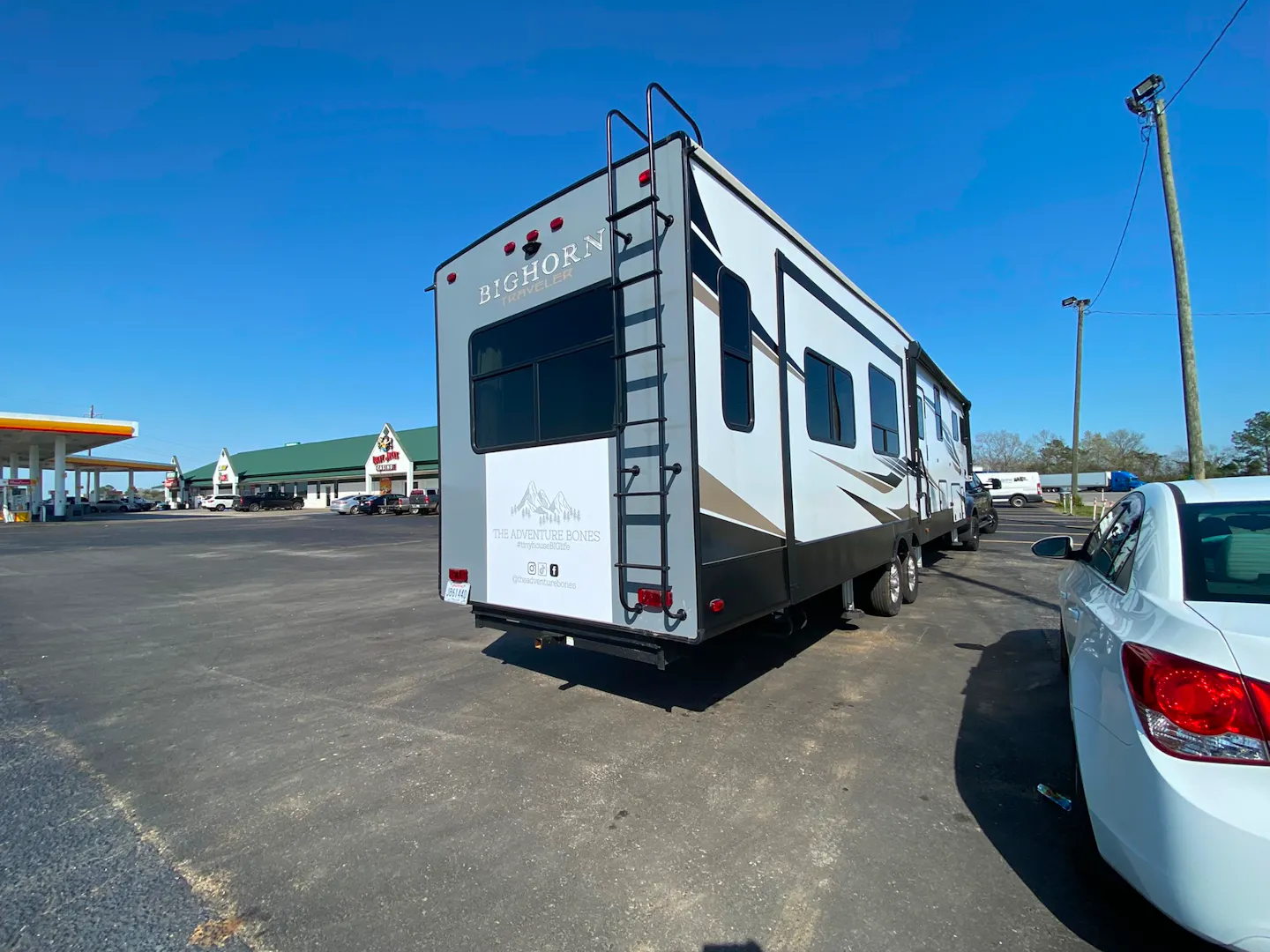 DARREN & AMANDA BONE's rv in a gas station parking lot