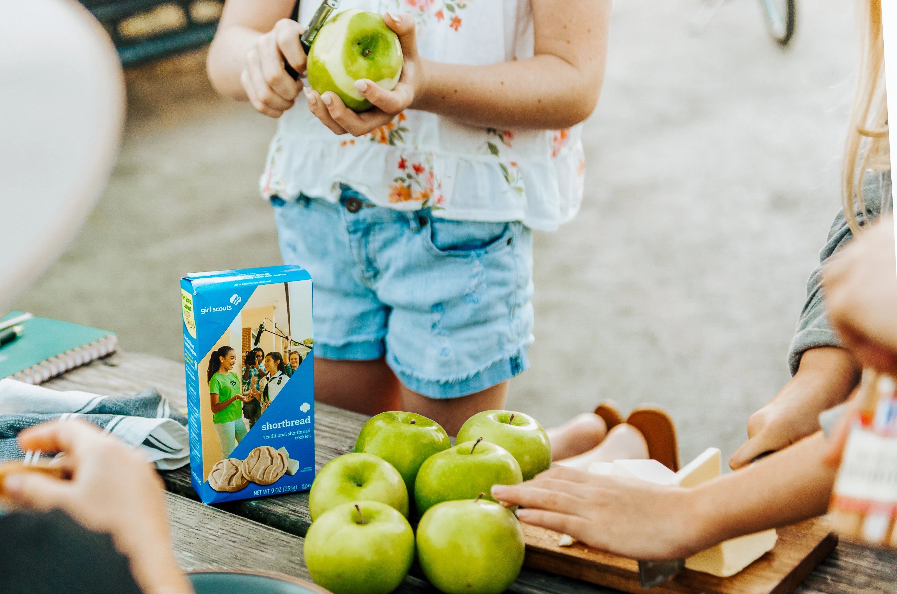 Girls peeling green apples