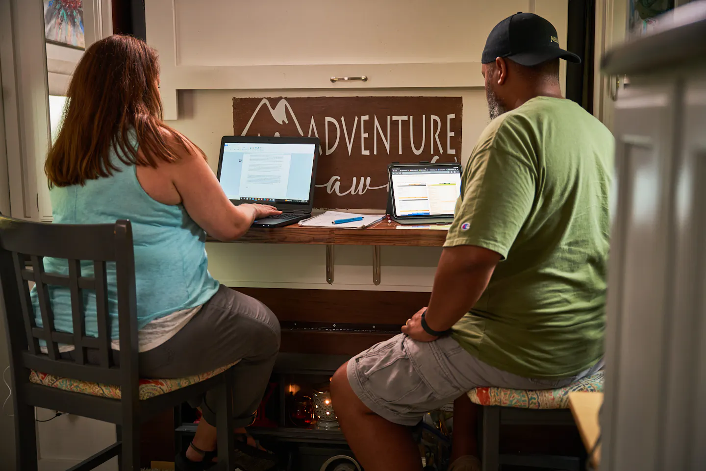 Ben and Christina McMillan working on their laptops inside their RV