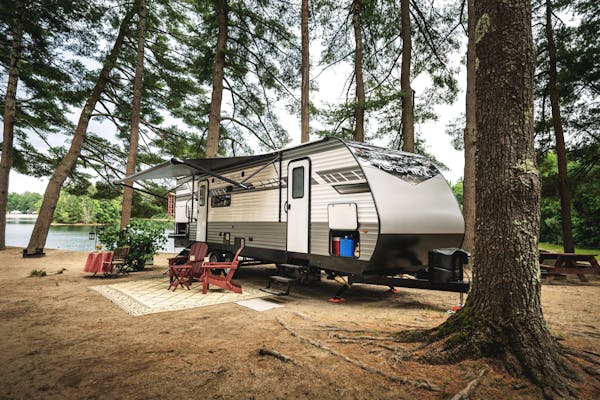 A travel trailer parked by a lake