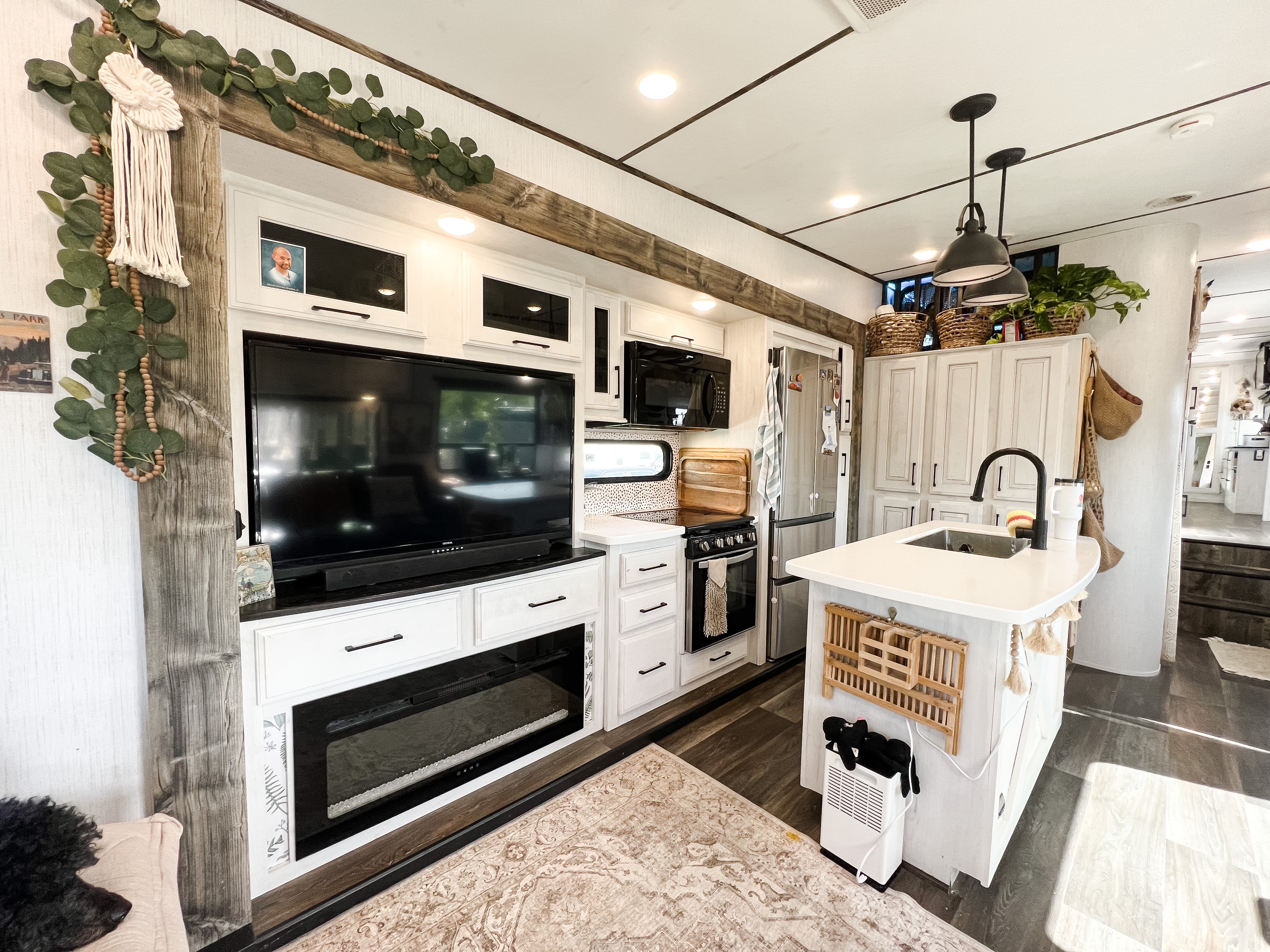 Amanda and Darren Bone family, Heartland Bighorn Traveler 39MB fifth wheel, living room with TV and kitchen interior 