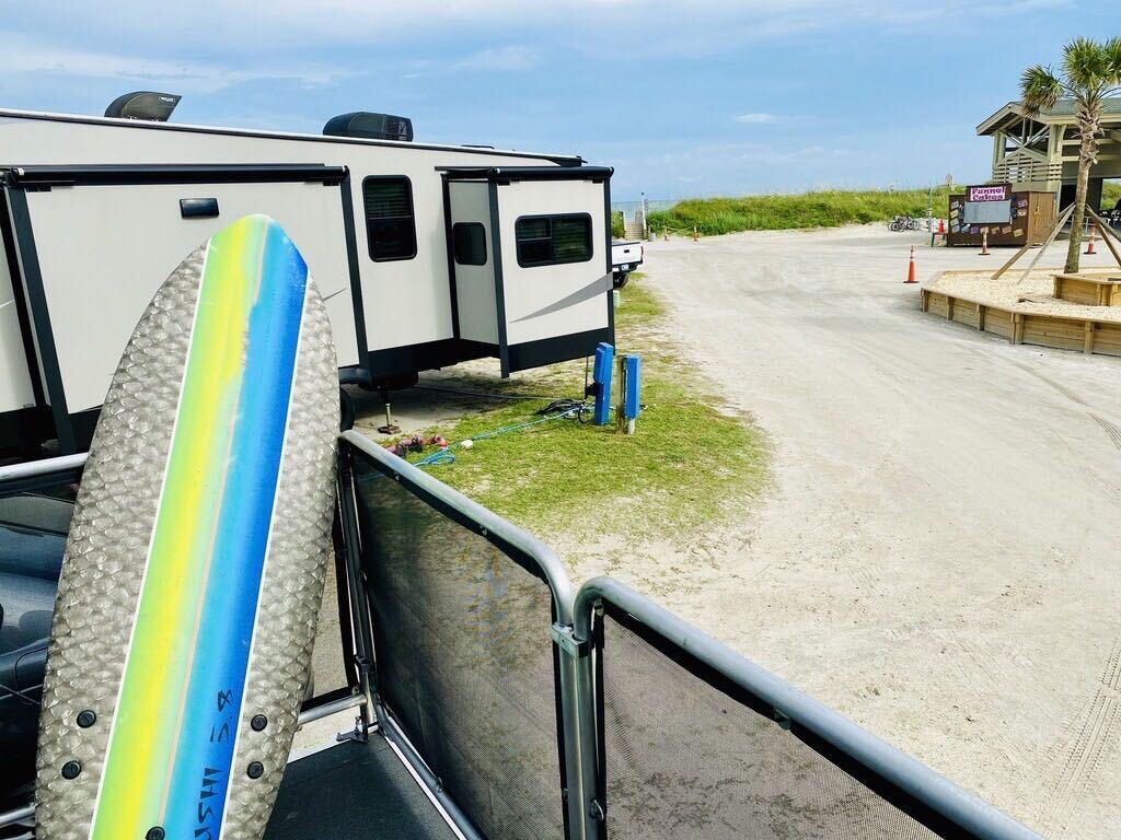 Eric Hannan's RV parked in a sandy campsite.