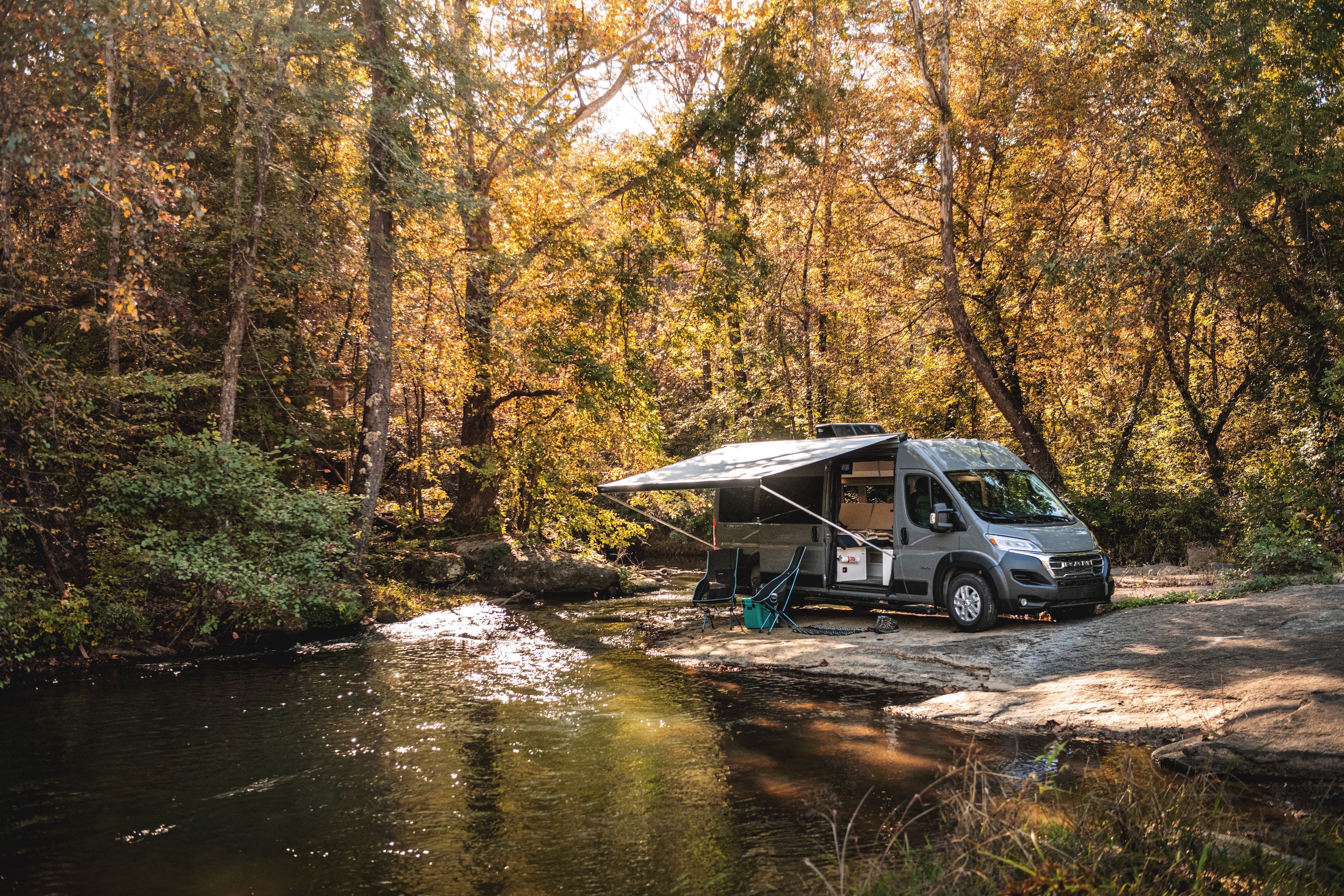 Jayco Swift camping next to a river