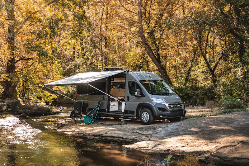 Jayco Swift camping next to a river