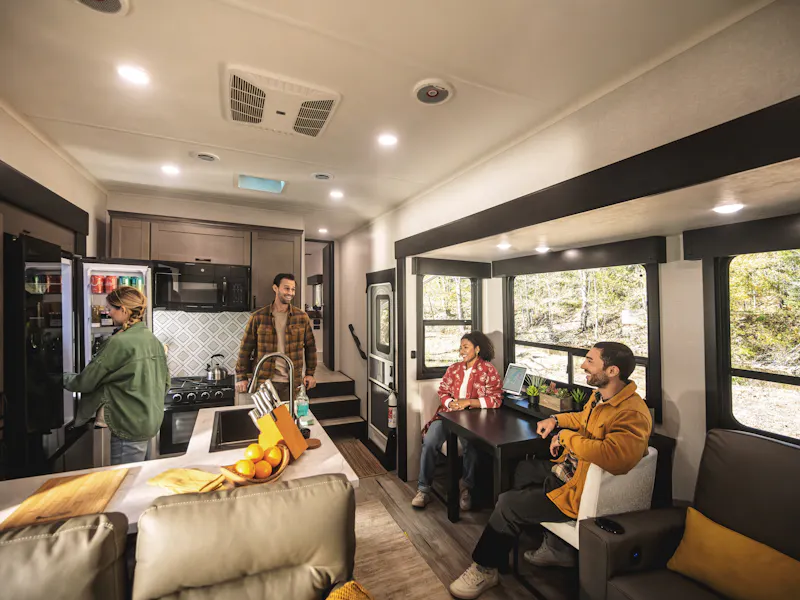 Group of friends chatting in an RV kitchen