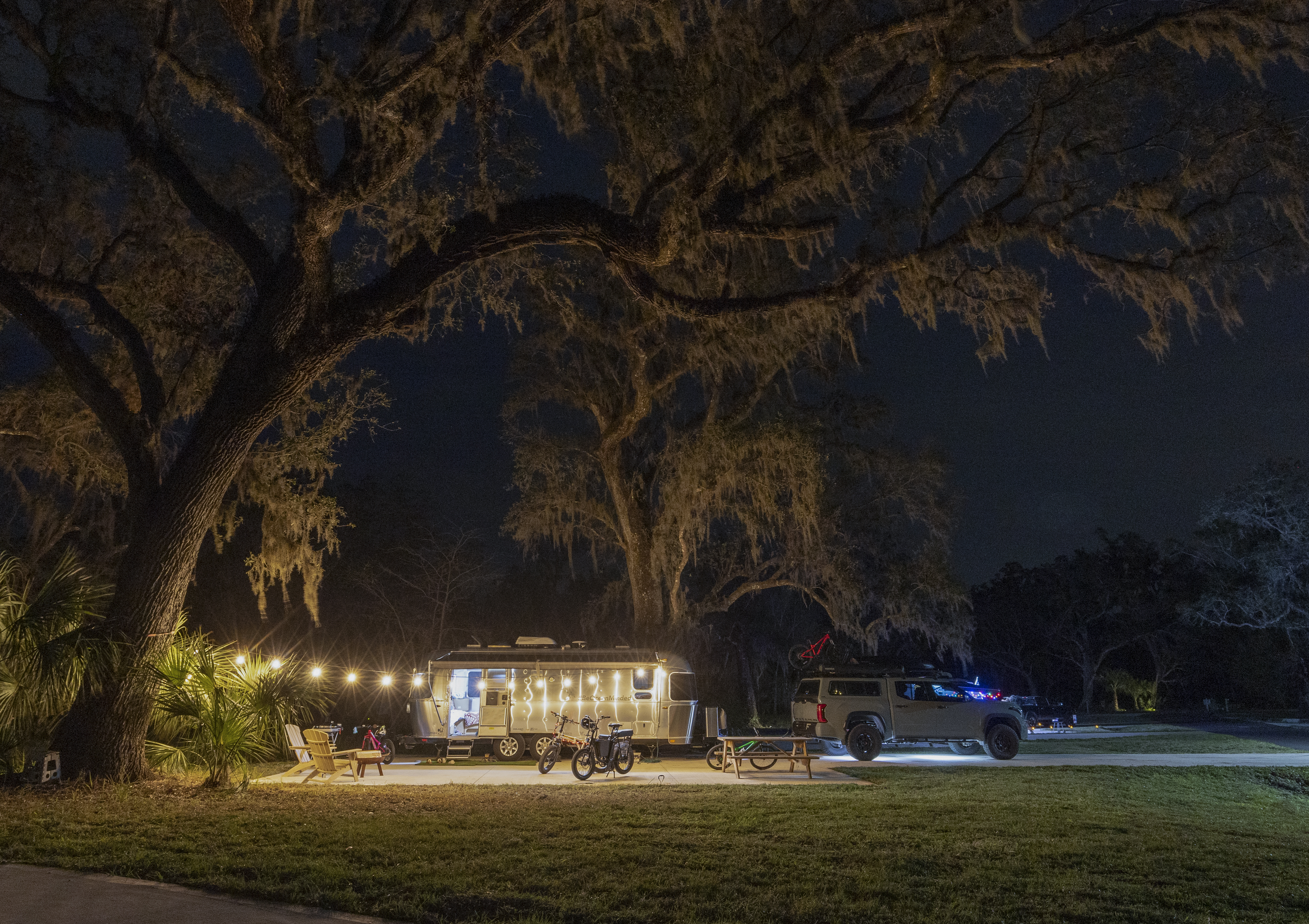 A tree-covered campsite featuring Ben Hicks' Airstream Flying Cloud.