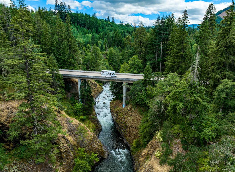 A Jayco Melbourne Class C motorhome driving across a bridge.