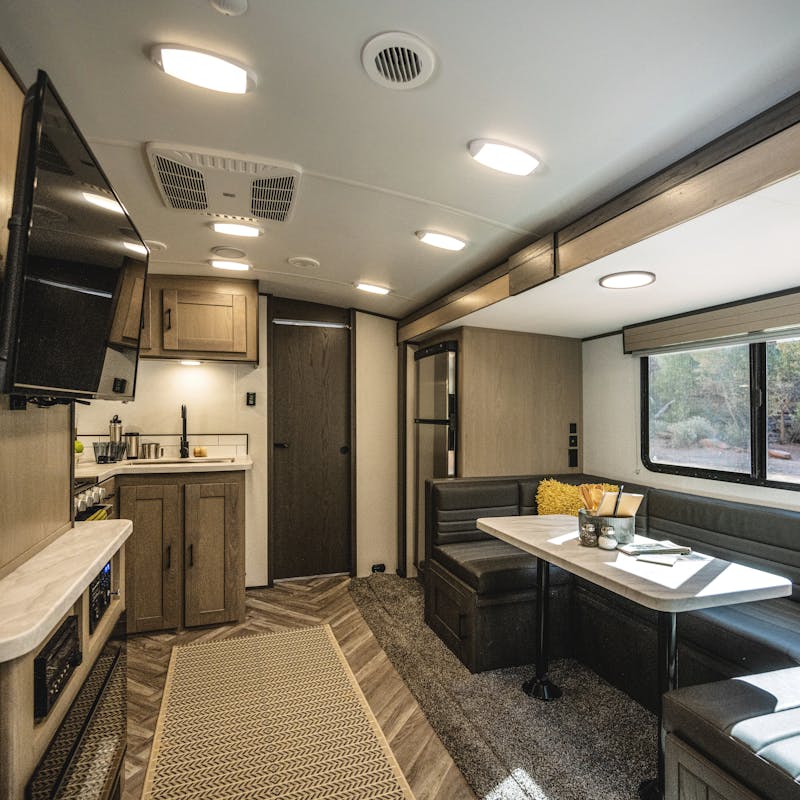 The interior of a Shadow Cruiser, including a dinette and living room.