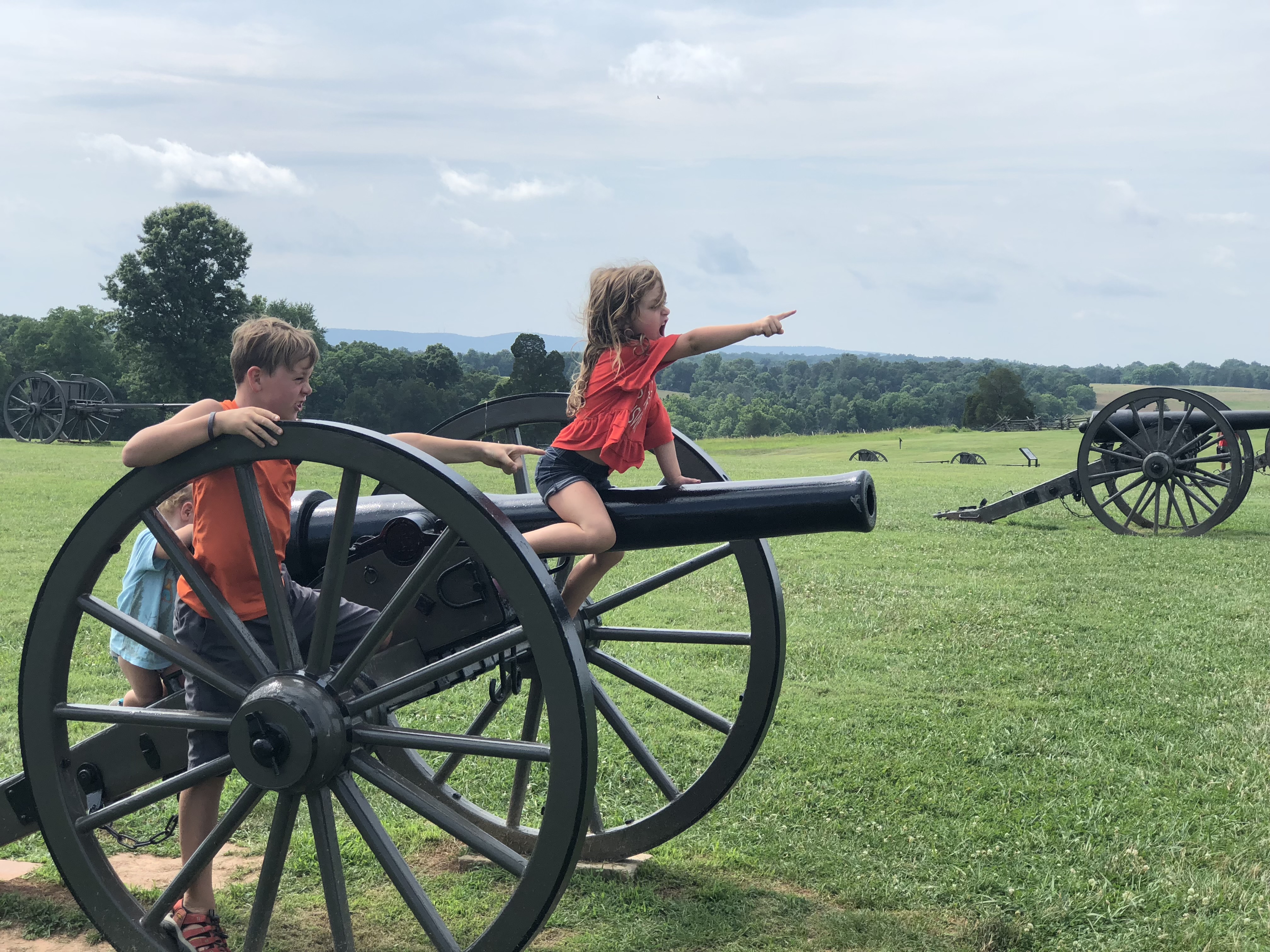 The Melissa and Lucas Lahr family next to historical artifacts.