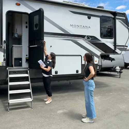 Bailey and Nicole Damberg explore different RVs at an RV show.