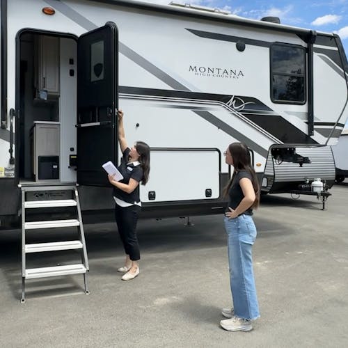 Bailey and Nicole Damberg explore different RVs at an RV show.