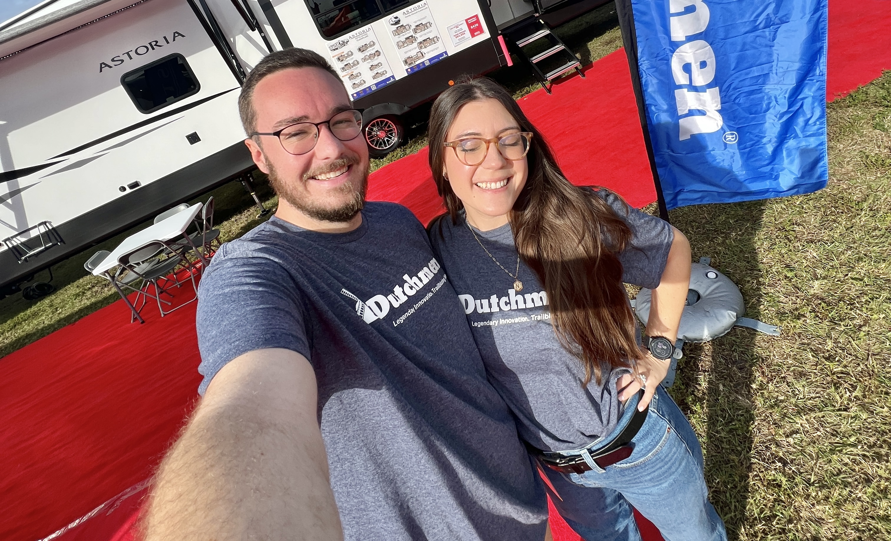 Bailey and Nicole Damberg pose in front of an RV at the Florida RV SuperShow.
