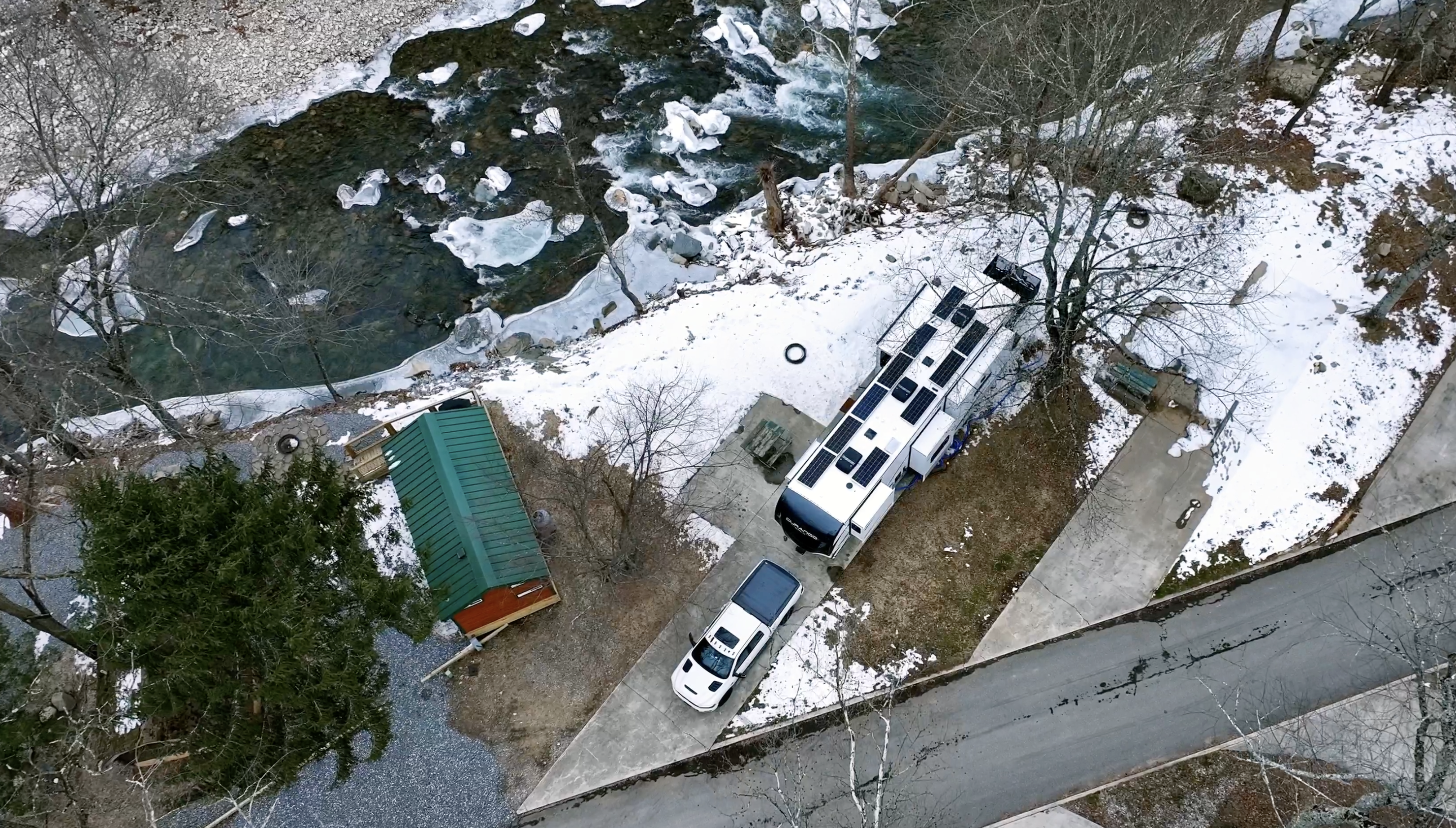 Bailey and Nicole Damberg's KZ RV Durango Gold fifth wheel next to a river in winter.