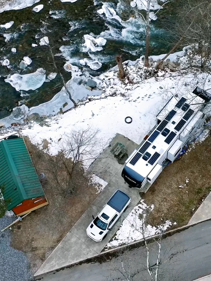 Bailey and Nicole Damberg's KZ RV Durango Gold fifth wheel next to a river in winter.