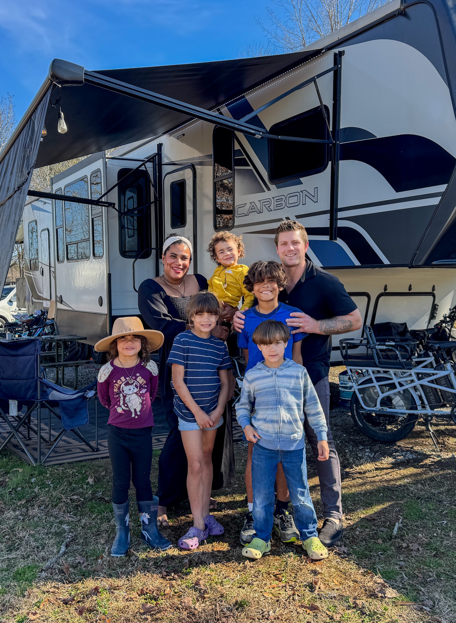 Josh and Keren Stolvoort and their kids next to their RV.