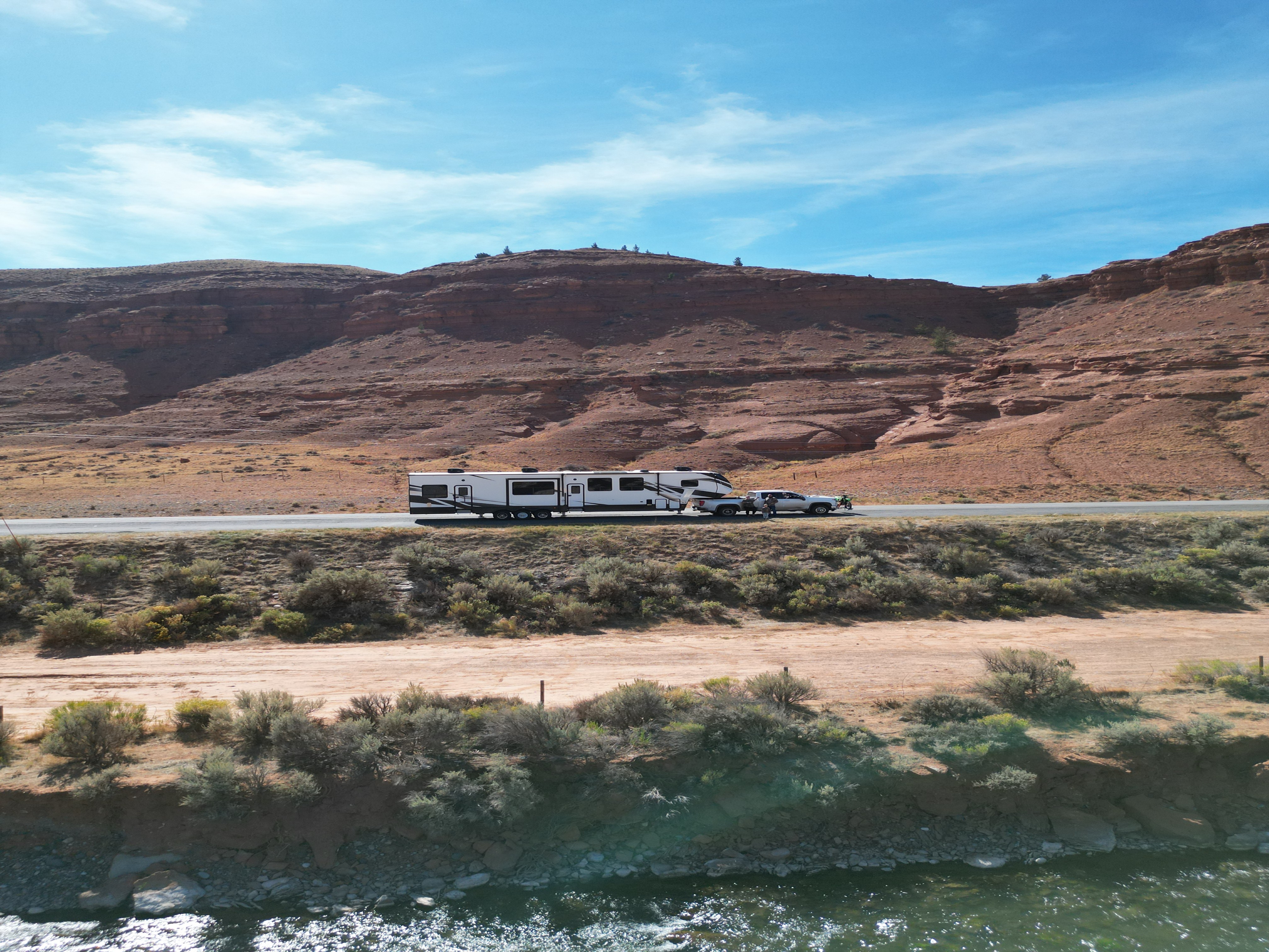 Jessica and Zachary White's Dutchmen Voltage Triton toy hauler driving through the desert.