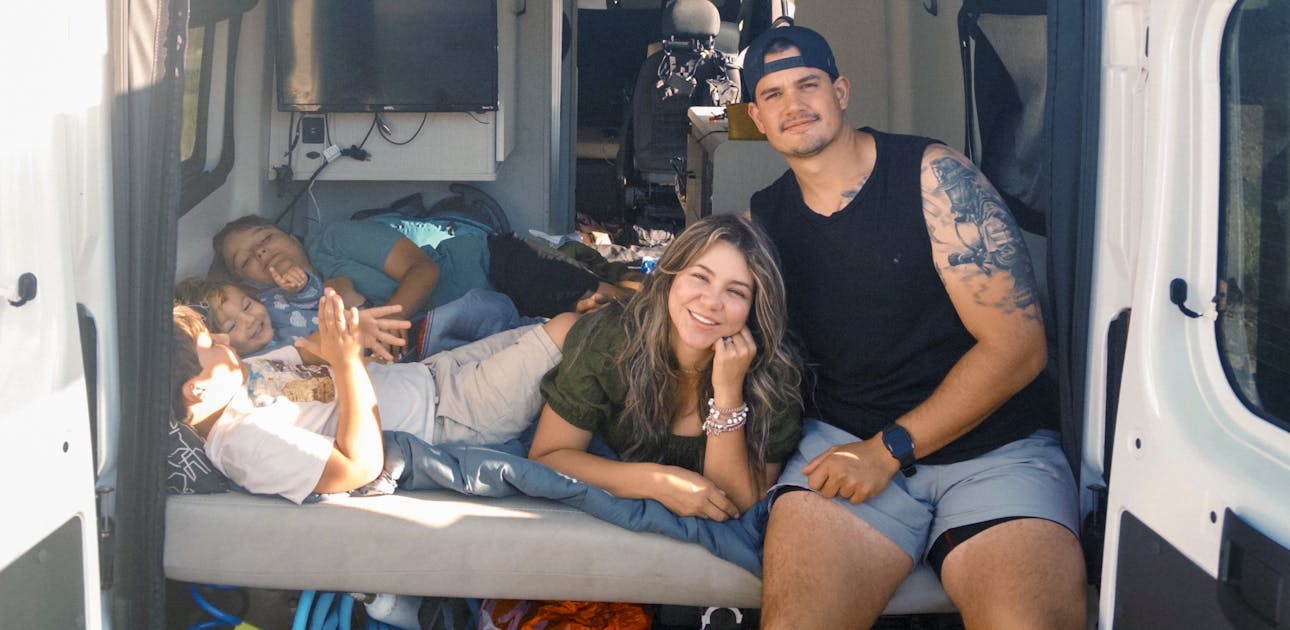 The Sebas and Sara Arango family sitting inside their Thor Motor Coach Twist camper van.