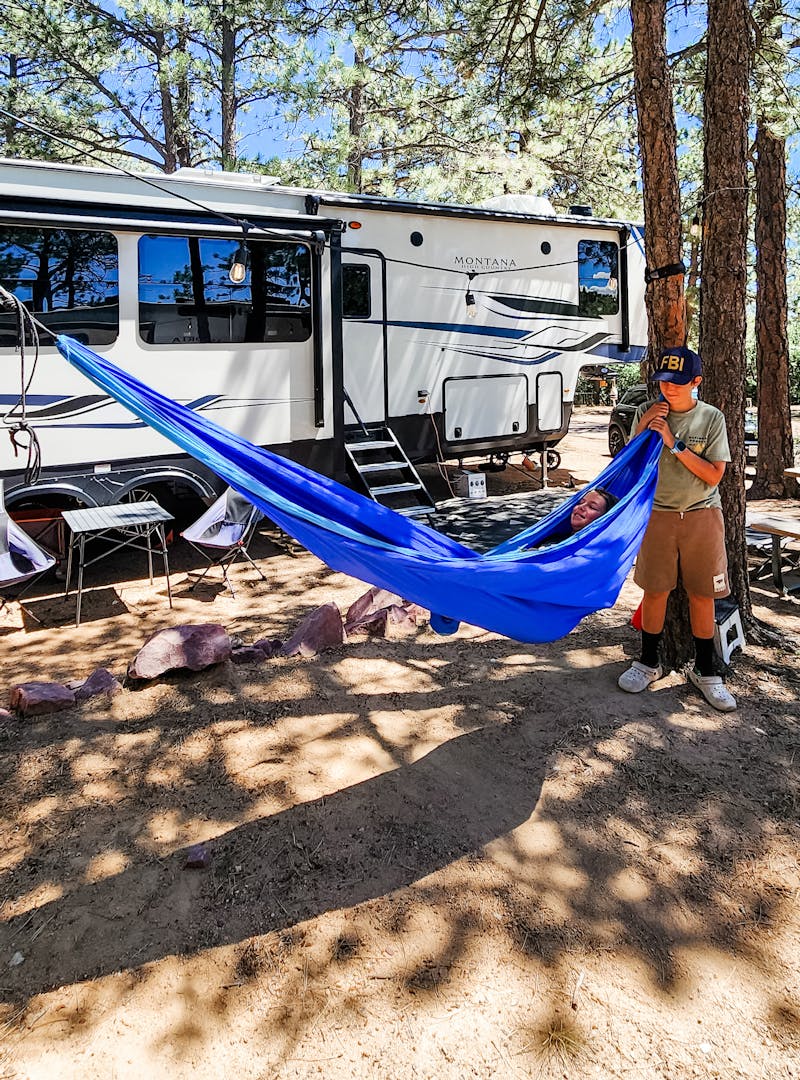 Kaylee and Steve Techau's Keystone Montana High Country fifth wheel and a hammock setup.
