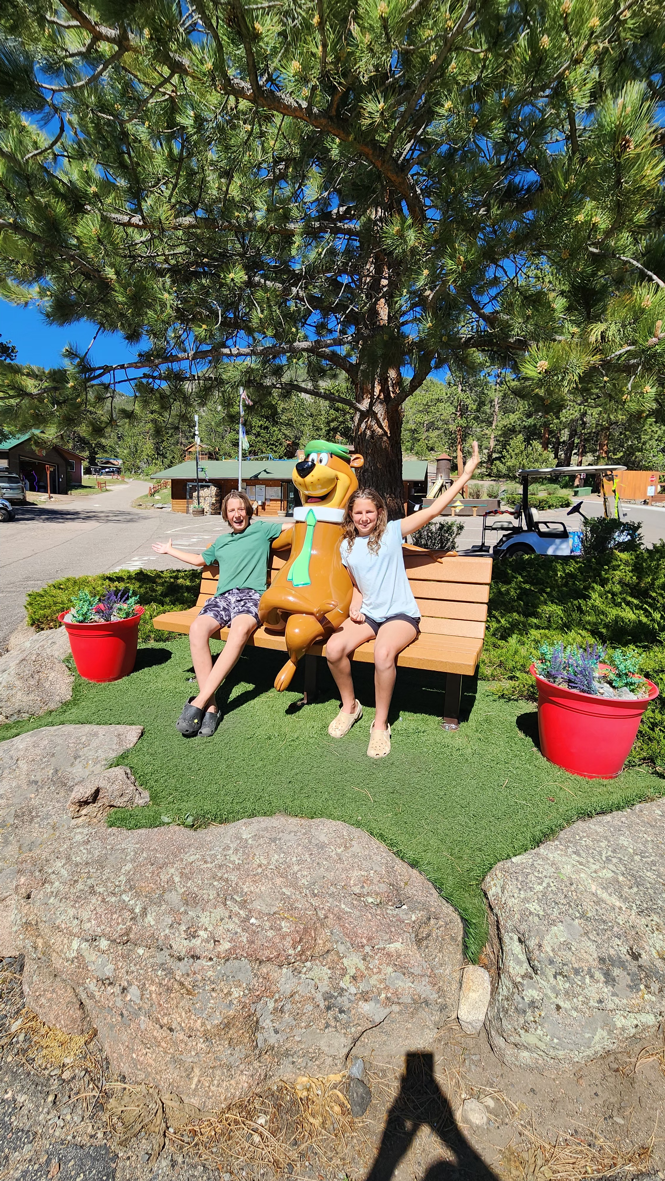 Kaylee and Steve Techau's kids pose next to Yogi Bear.