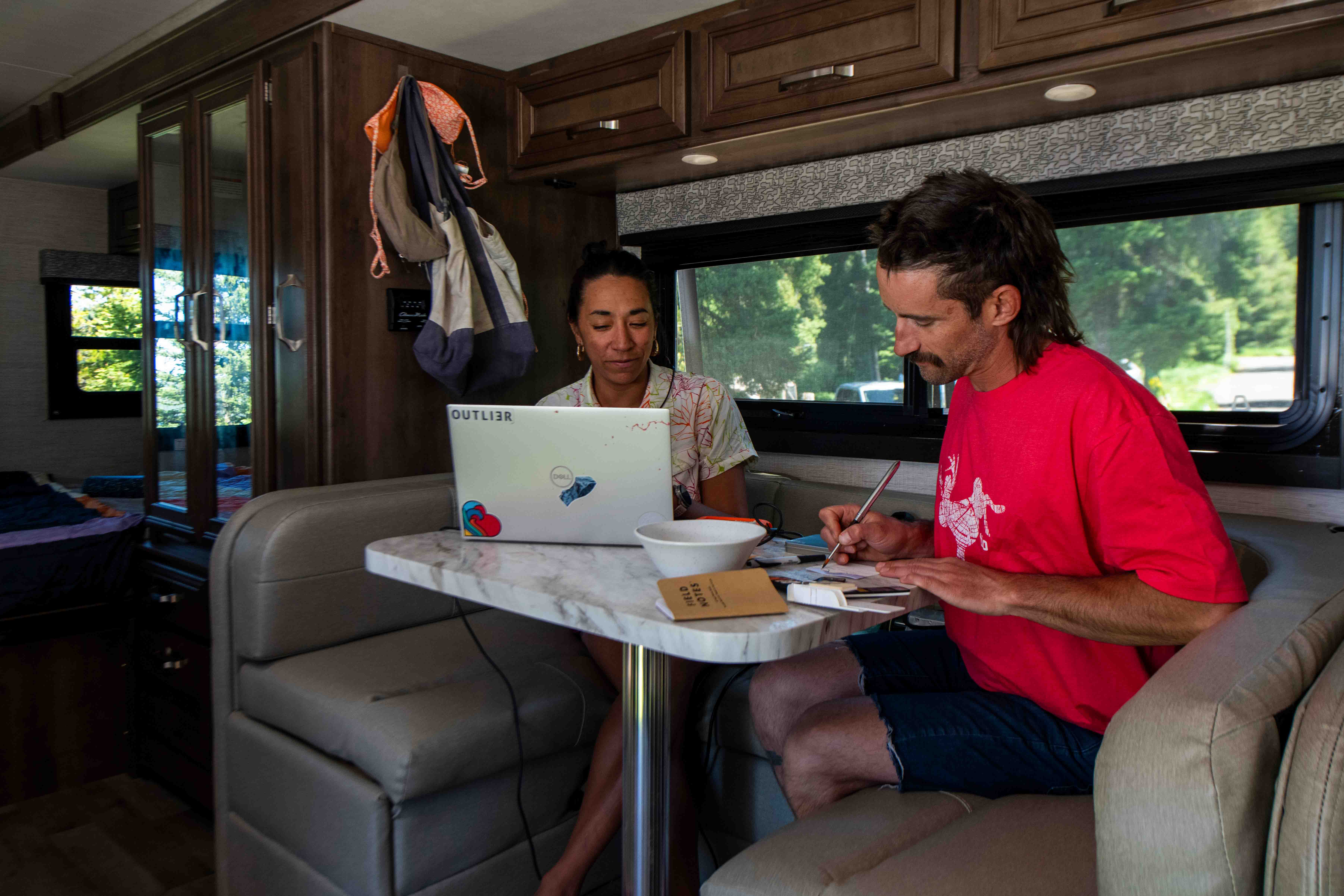 Dani Reyes-Acosta and her partner Johnny doing activities at the dinette inside a Jayco Melbourne.