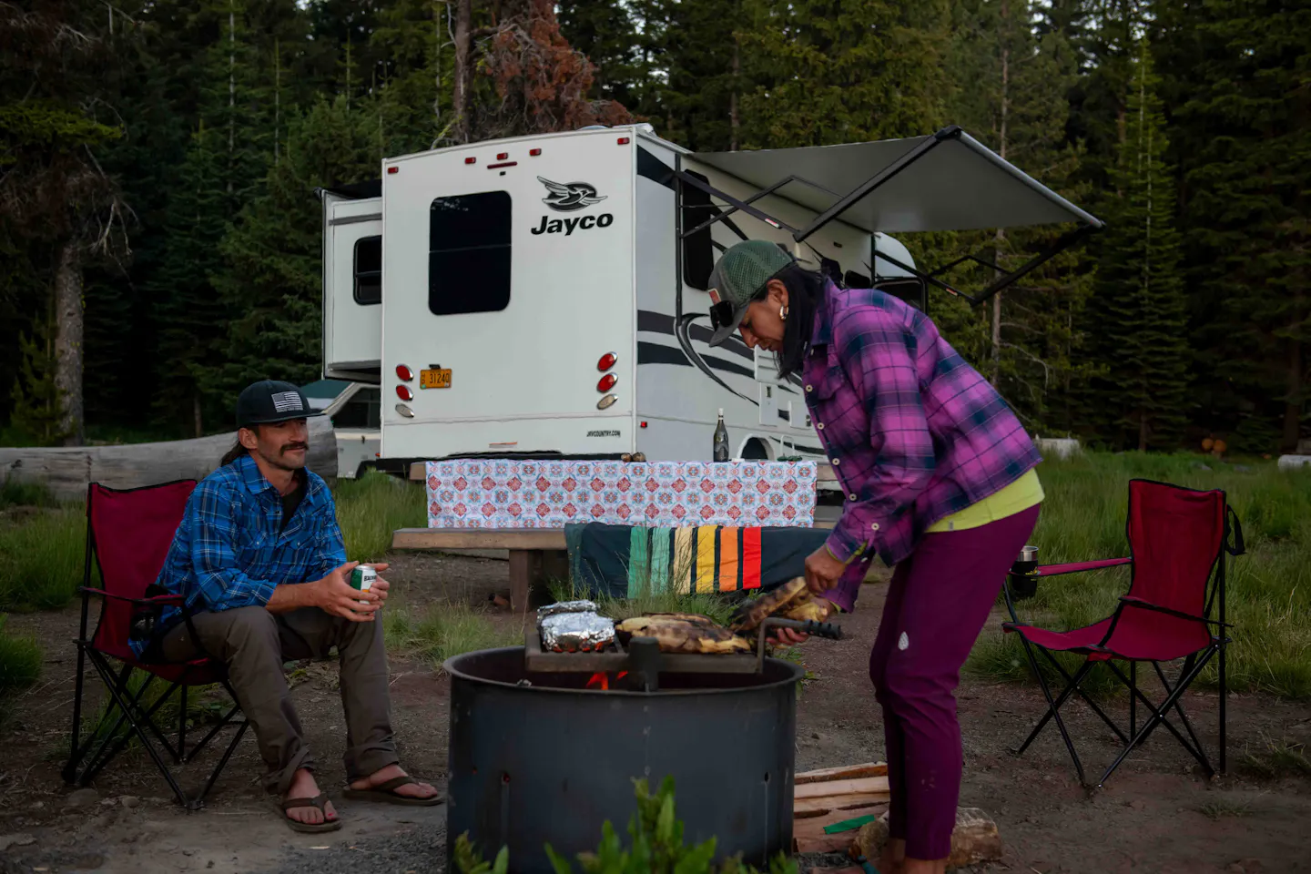 Dani Reyes-Acosta and her partner Johnny gathered around a fire ring.