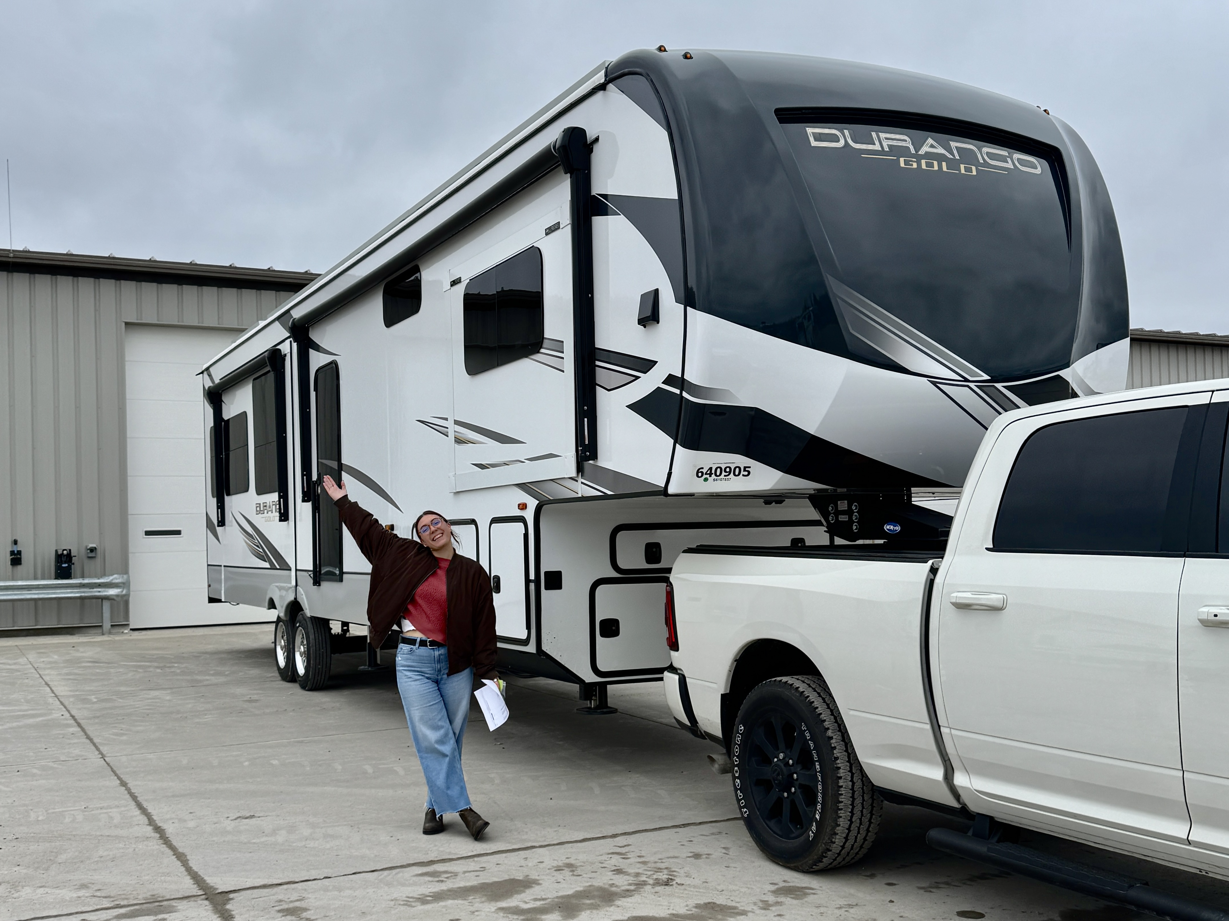 Nicole Damberh standing next to her new KZ Durango Gold fifth wheel.