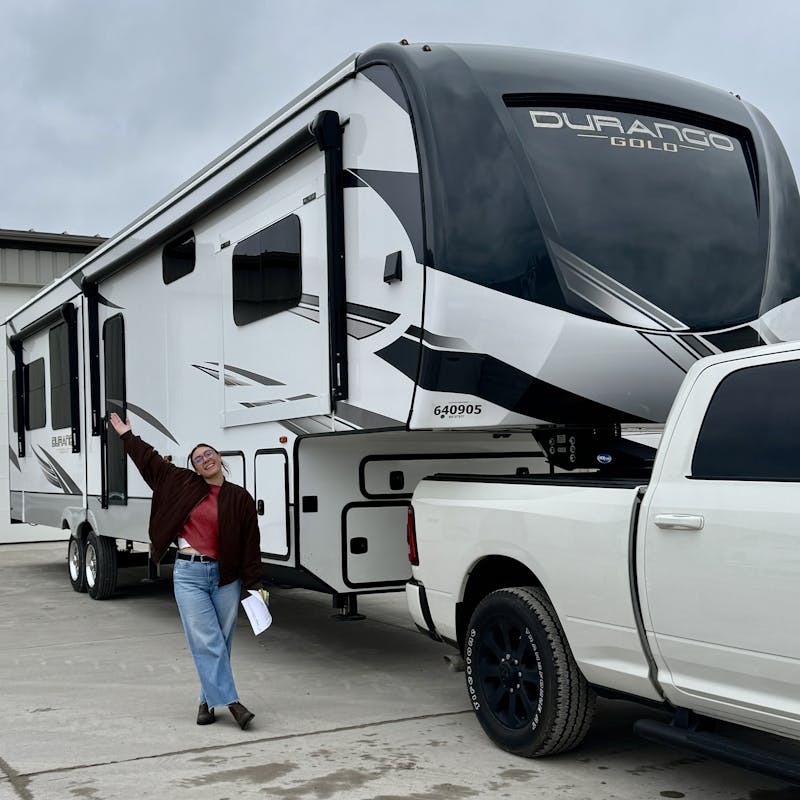 Nicole Damberh standing next to her new KZ Durango Gold fifth wheel.