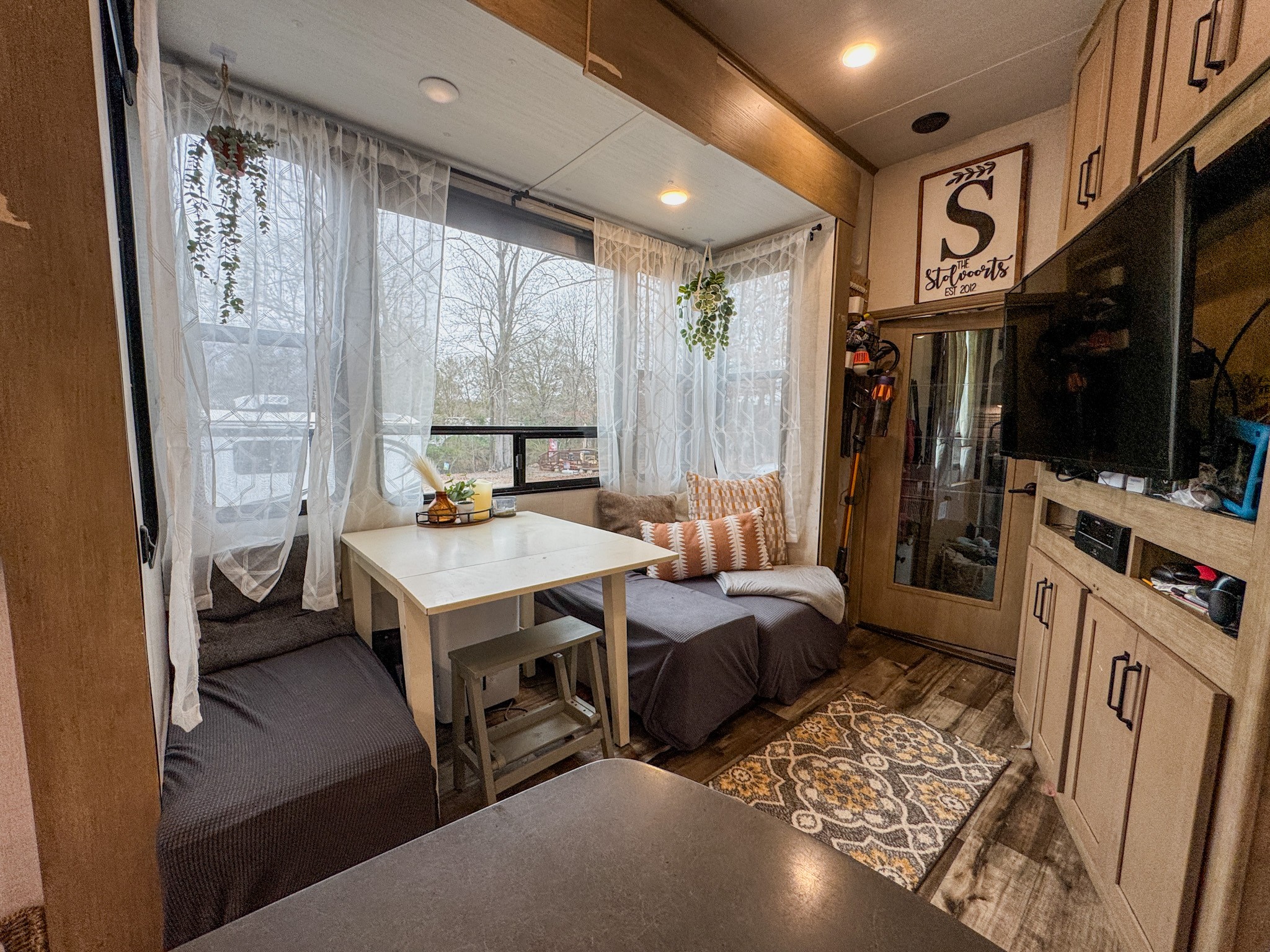 The dinette and living area inside Josh and Keren Stolvoort's Keystone Carbon toy hauler.