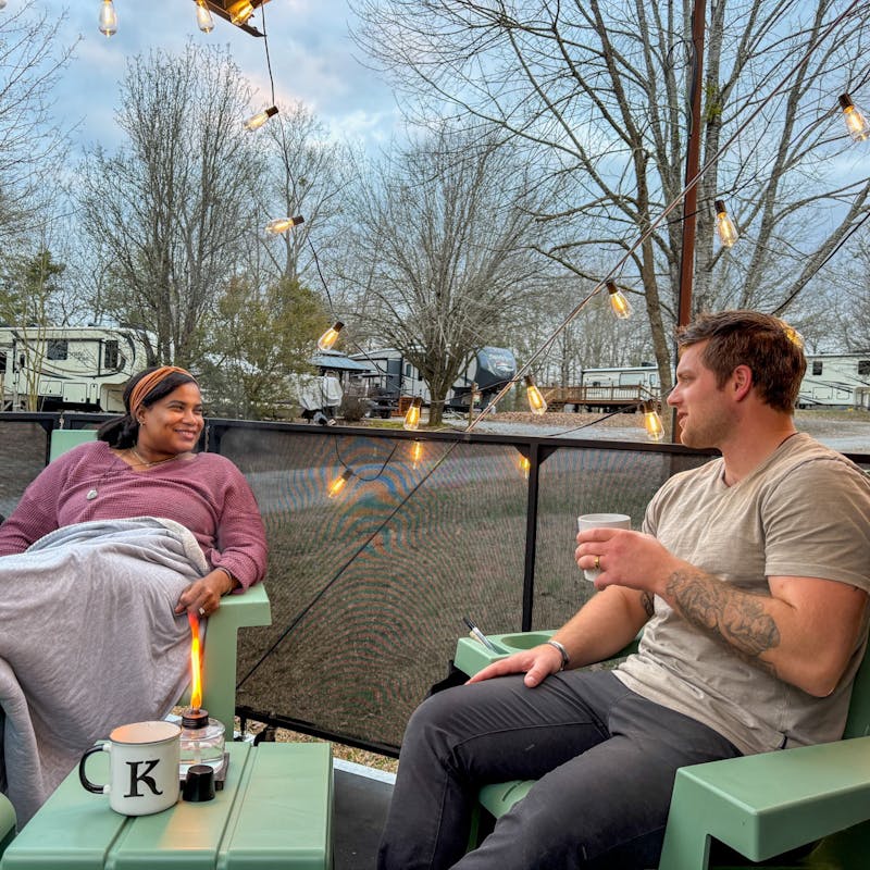 Josh and Keren Stolvoort sit on the patio of their Keystone Carbon toy hauler.