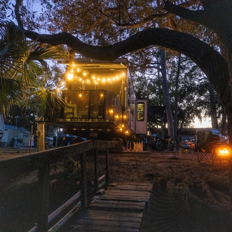 Josh and Keren Stolvoort's Keystone Carbon toy hauler at a campsite at night.