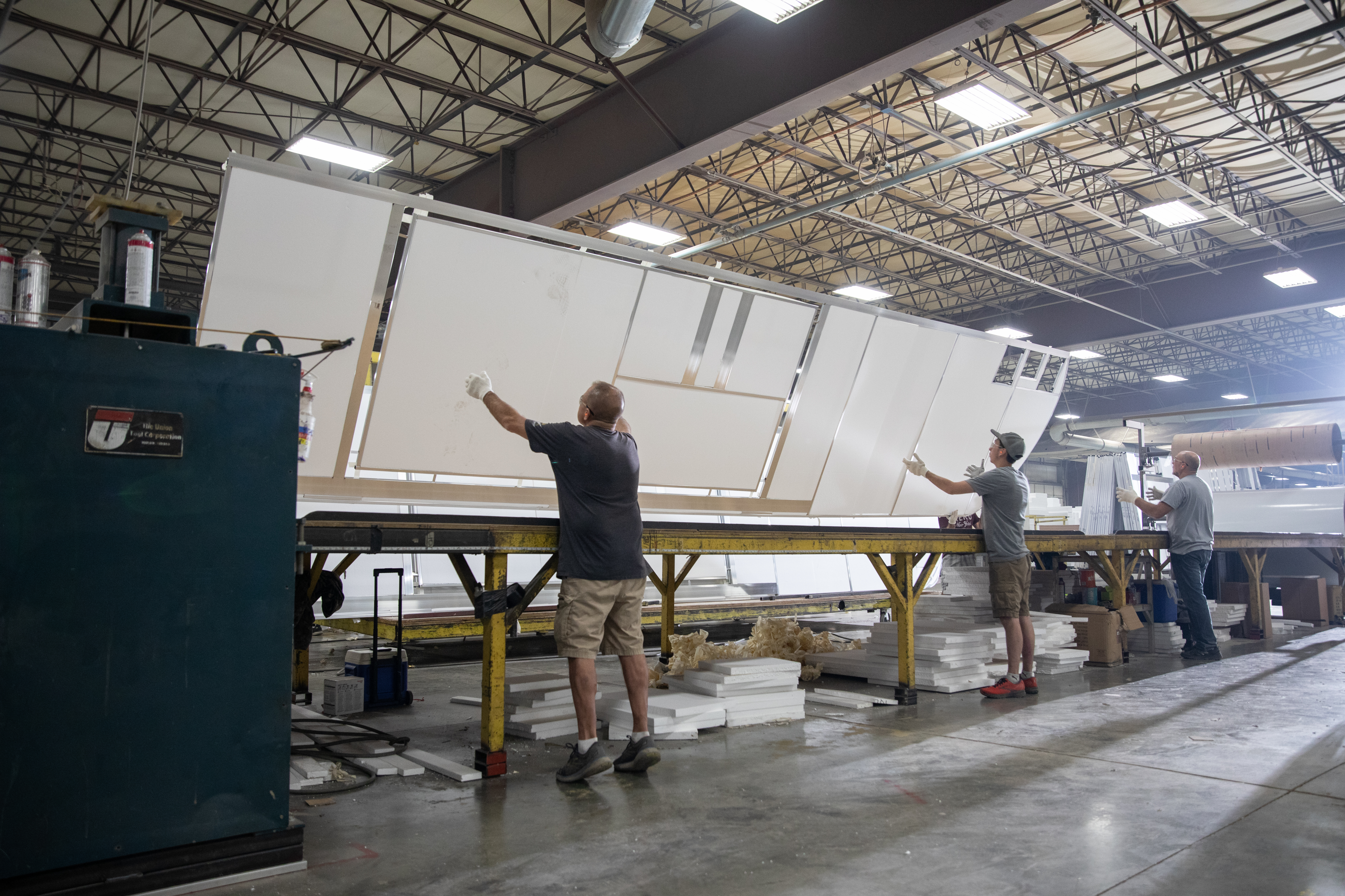 THOR Industries team members work with RV parts in a manufacturing center.