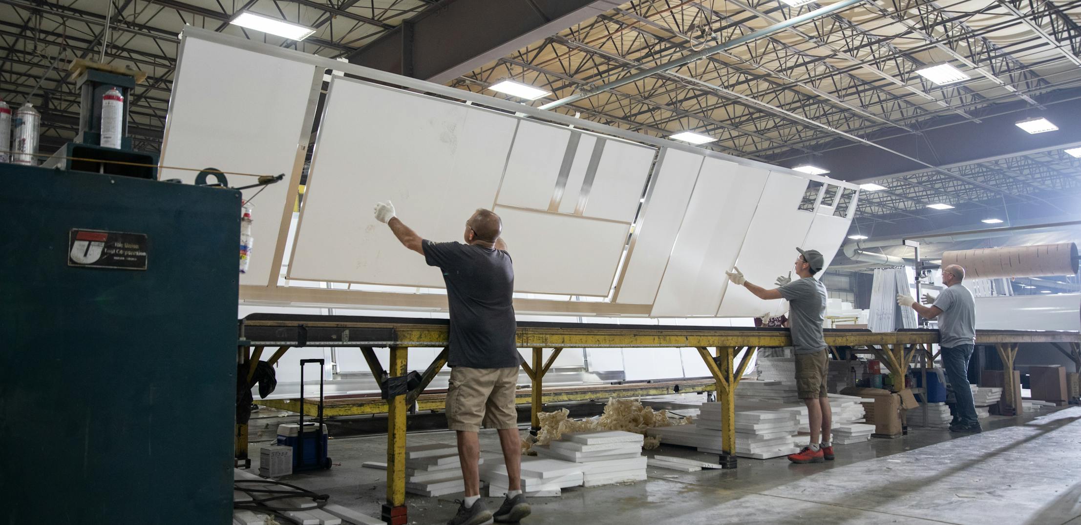 THOR Industries team members work with RV parts in a manufacturing center.
