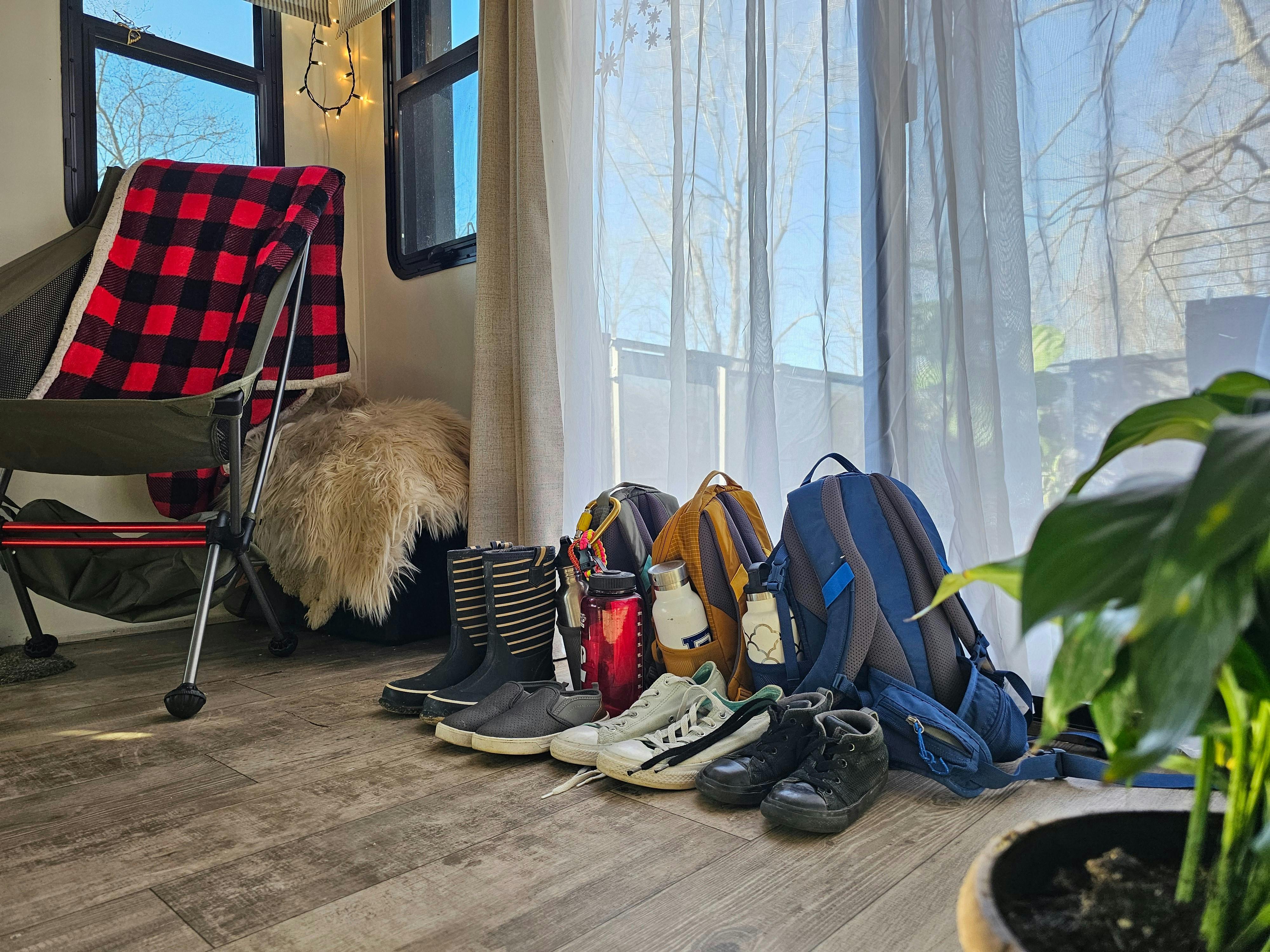 Shoes and emergency bags sit near the door inside JC and Bibi Barringer's KZ Durango fifth wheel.