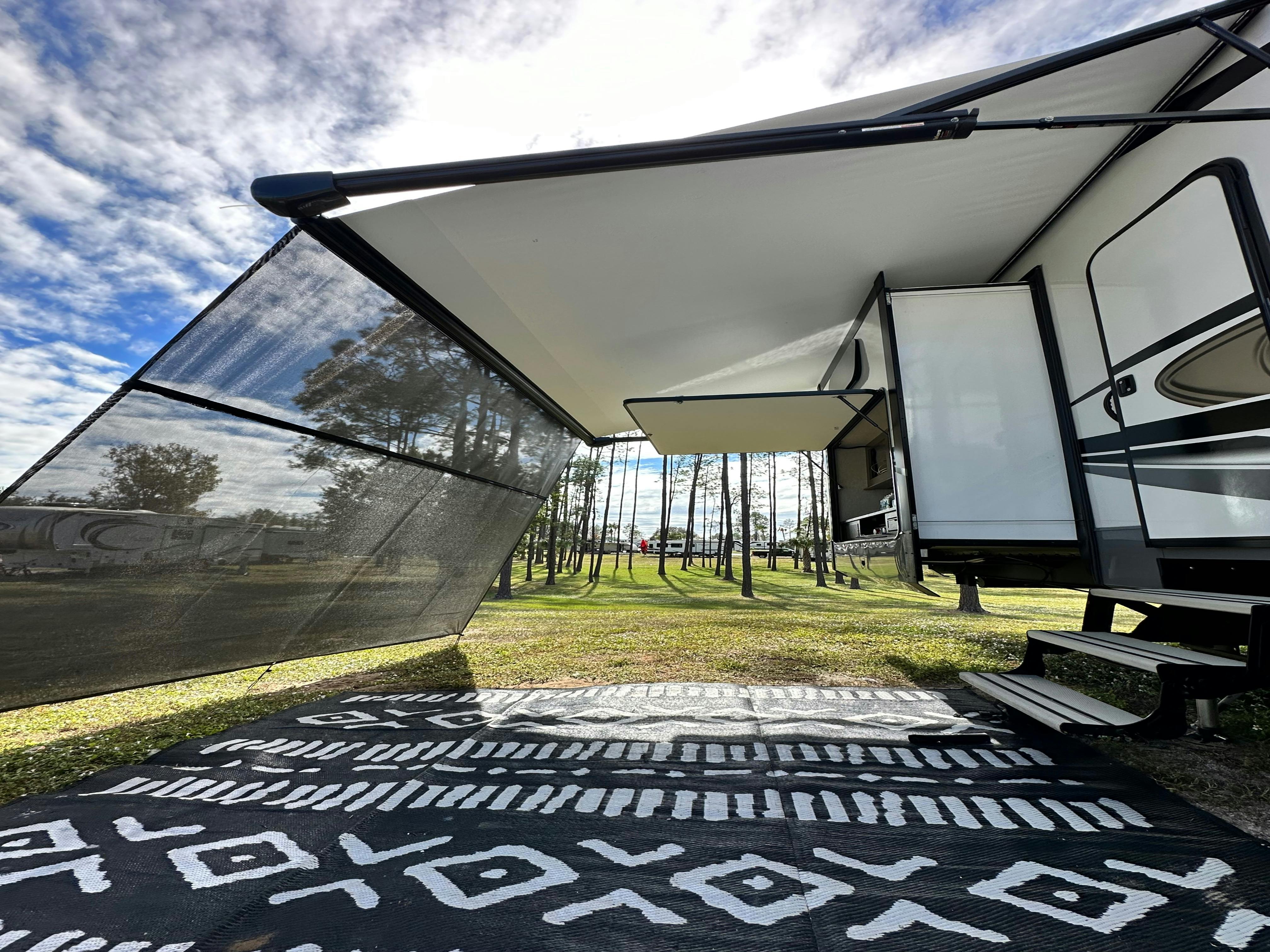 The awning and patio outside of Cassie and Joshua Bailey's Highland Ridge Open Range fifth wheel.