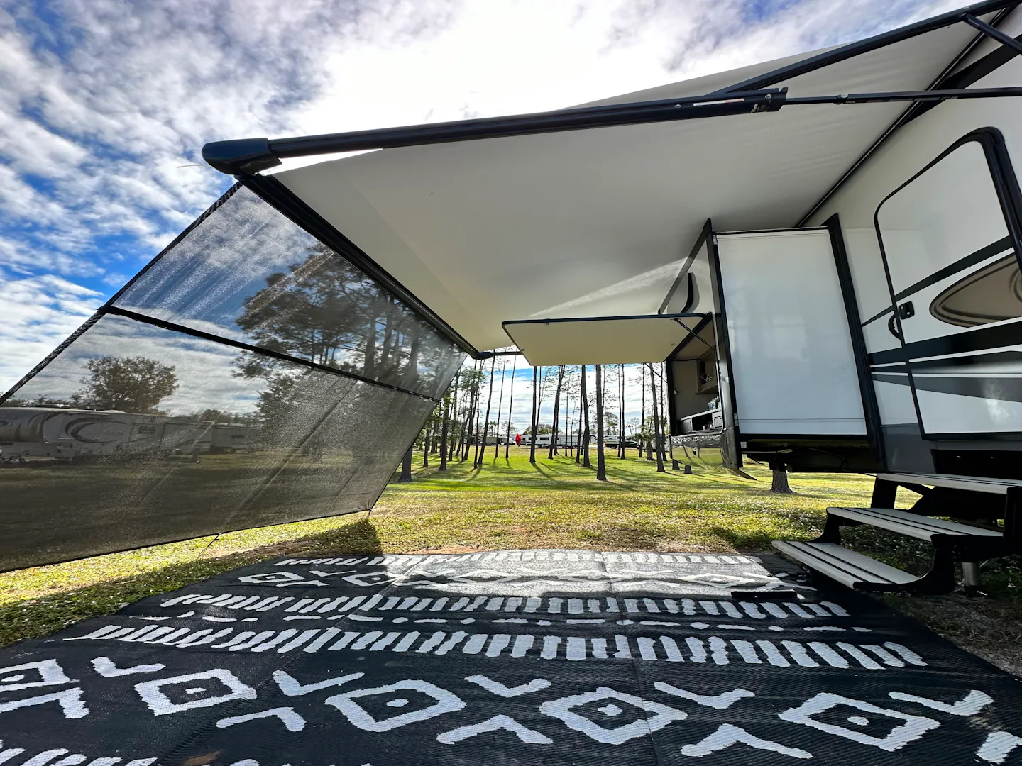 The awning and patio outside of Cassie and Joshua Bailey's Highland Ridge Open Range fifth wheel.