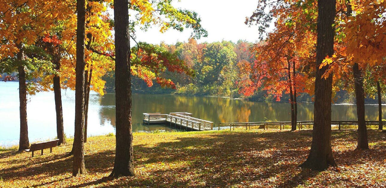 Fourche Lake pictured with a dock and fall foliage in Mark Twain National Forest.