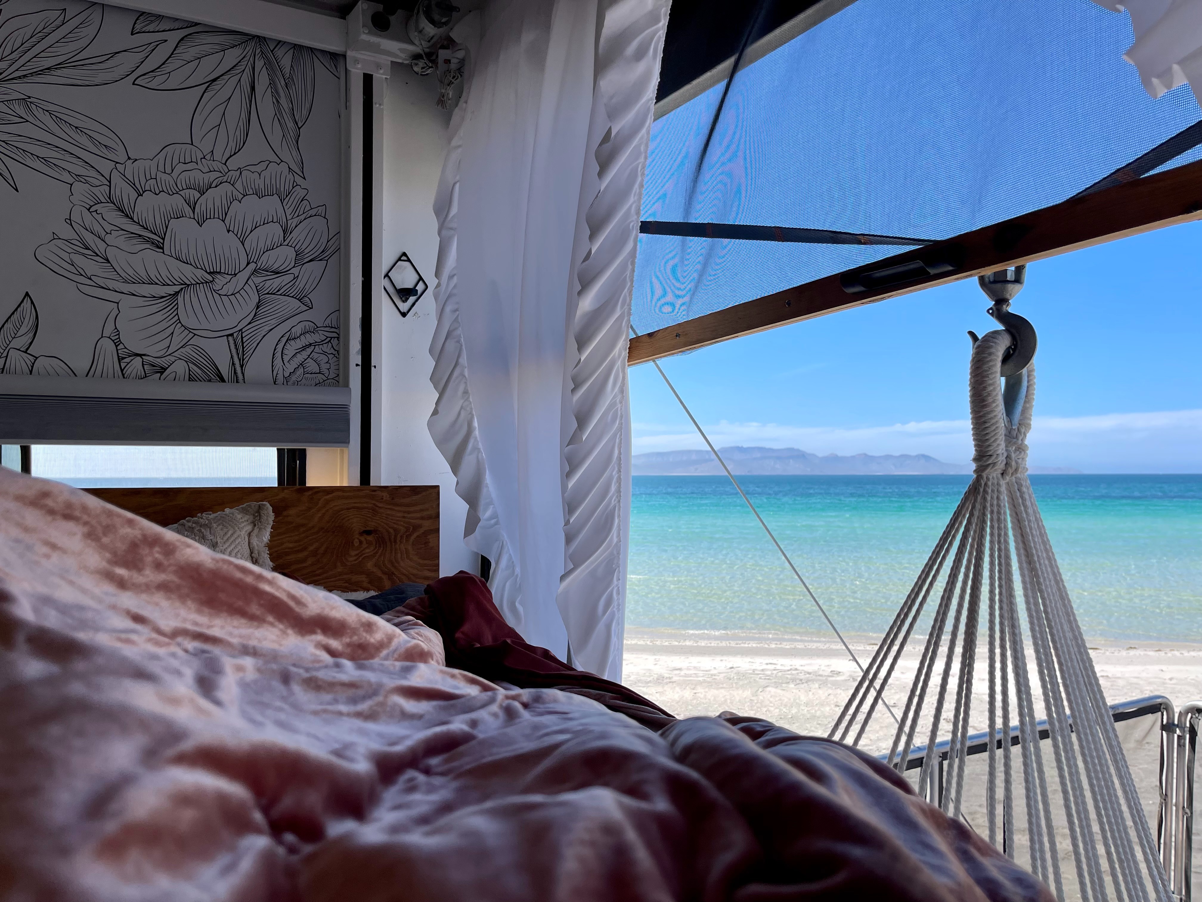 The view outside of Melissa and Lucas Lahr's RV looking at a blue ocean.