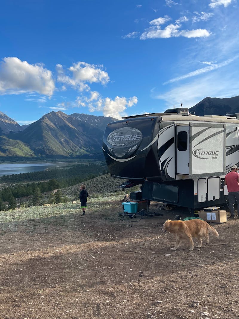 Melissa and Lucas Lahr's Heartland Torque toy hauler at a campsite with panoramic mountain views.