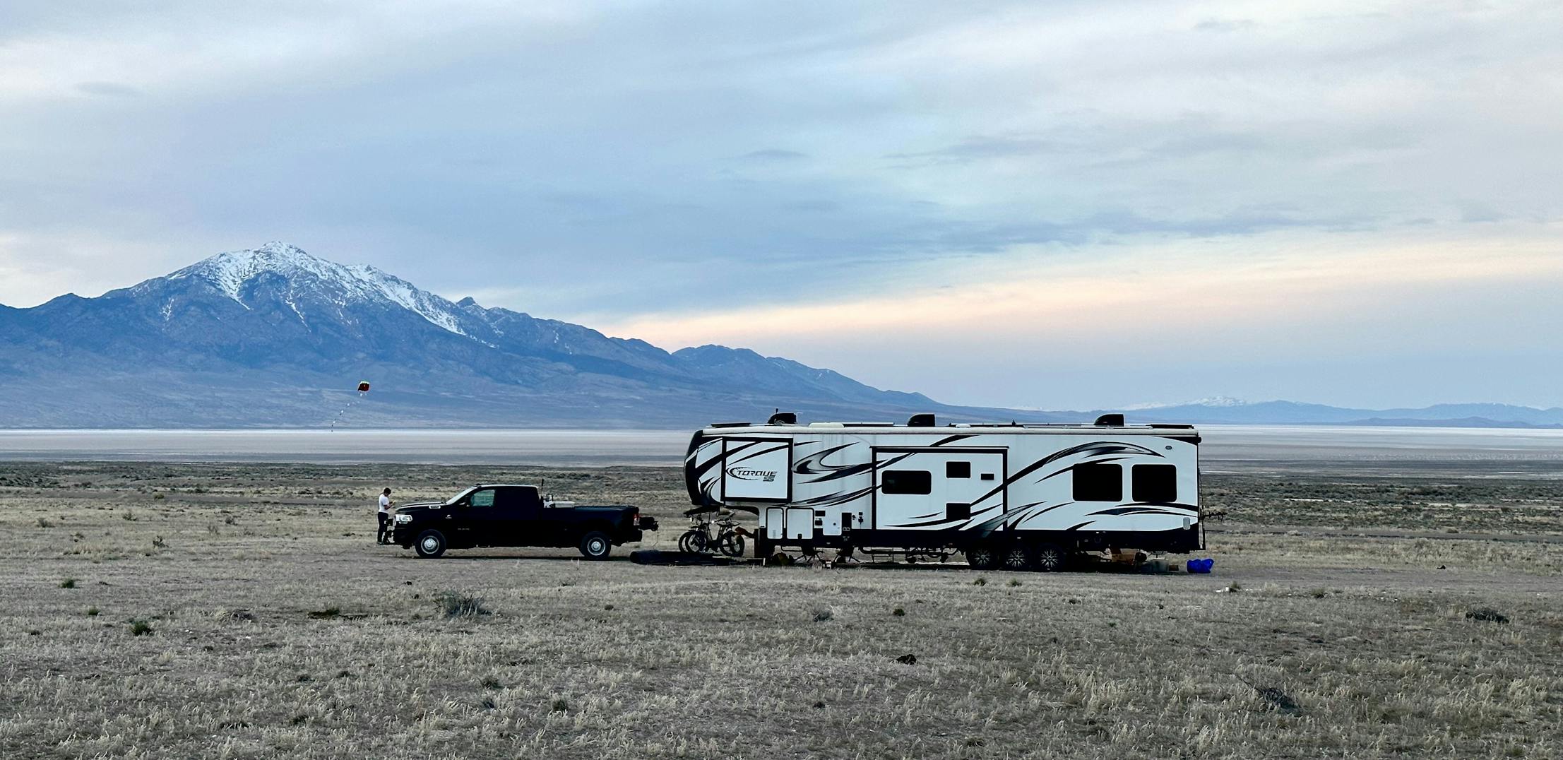 Melissa and Lucas Lahr's Heartland Torque toy hauler in expansive plains with the mountains in the background.