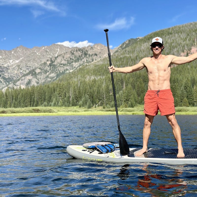 John King on a paddle board in the mountains.