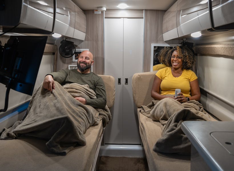 A TV on a swivel-mount and built-in Wi-Fi makes movies in bed easy inside Gabe and Rocio Rivero's Thor Motor Coach Sequence.