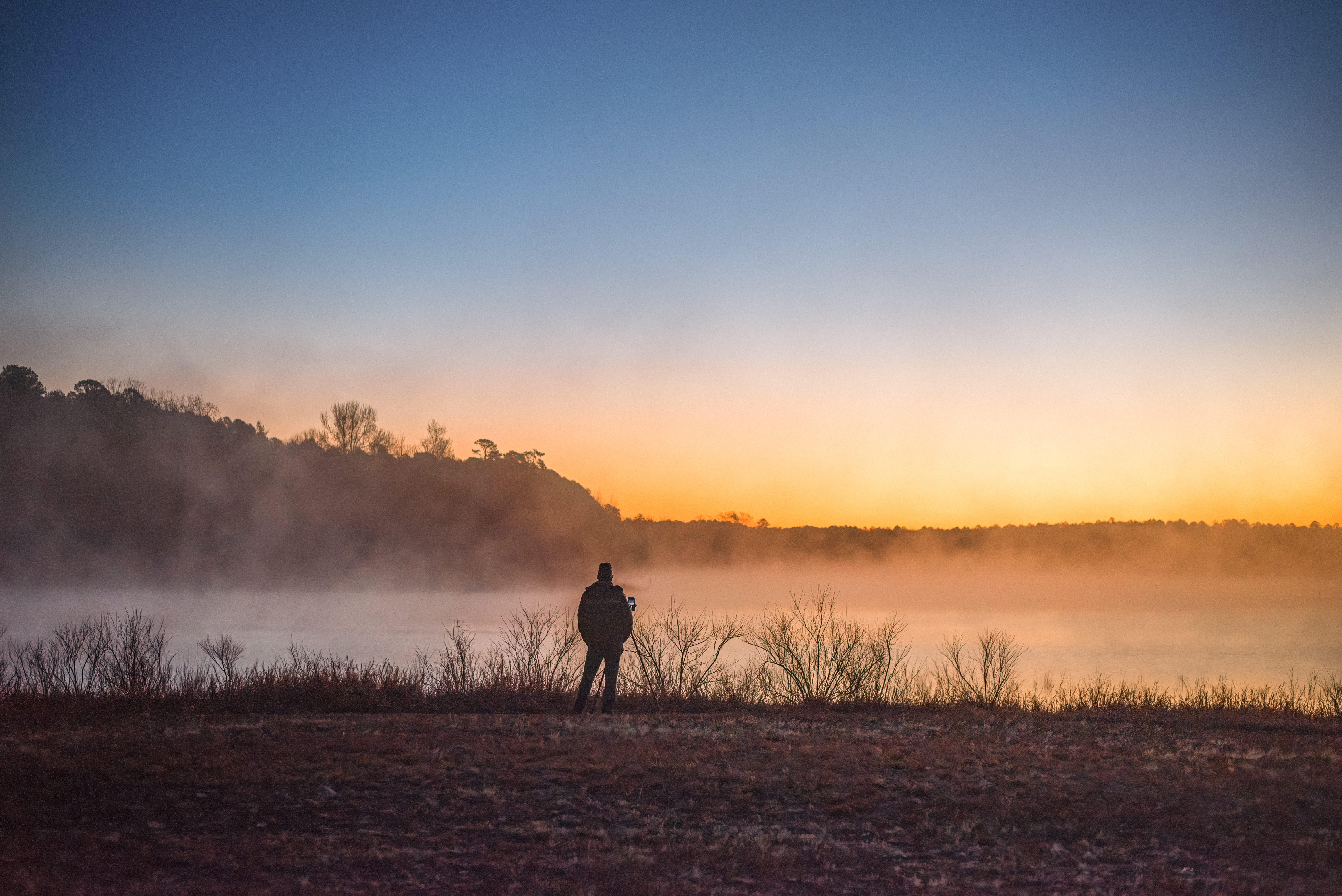 The Takacs standing at a foggy lake.