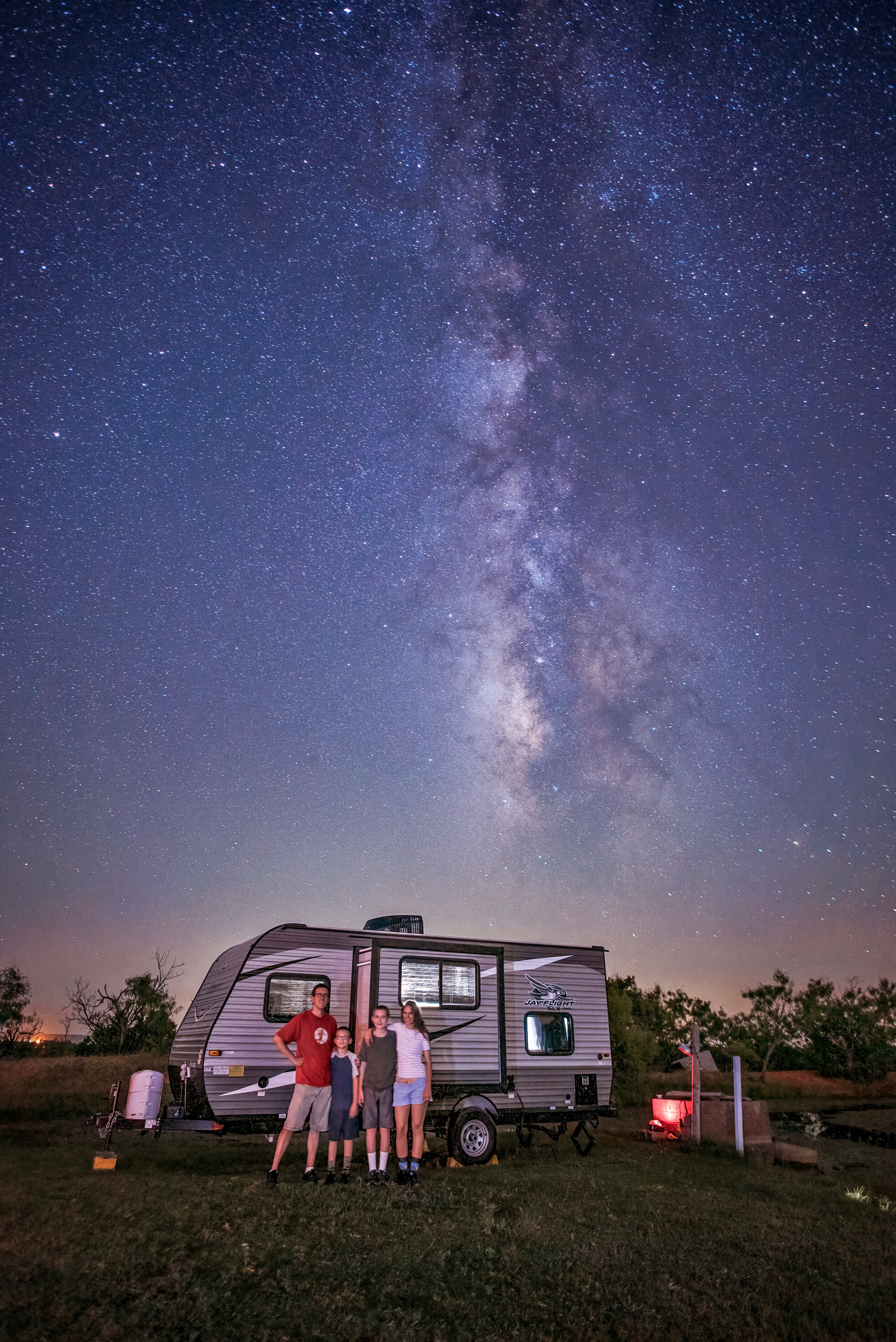 The Takacs family stargazes next to their Jayco Jay Flight travel trailer.