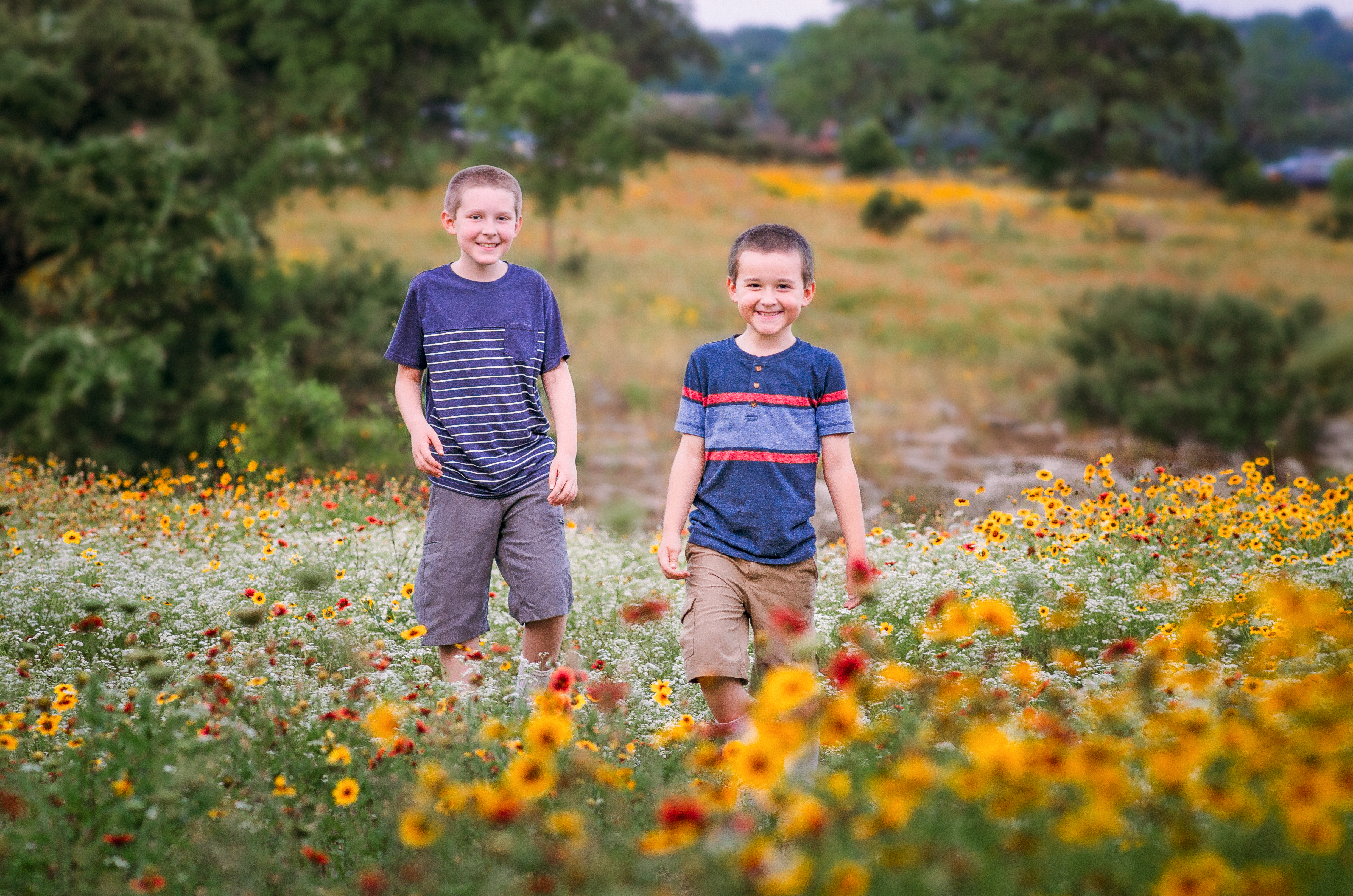 The Takacs kids standing in a wildflower field.