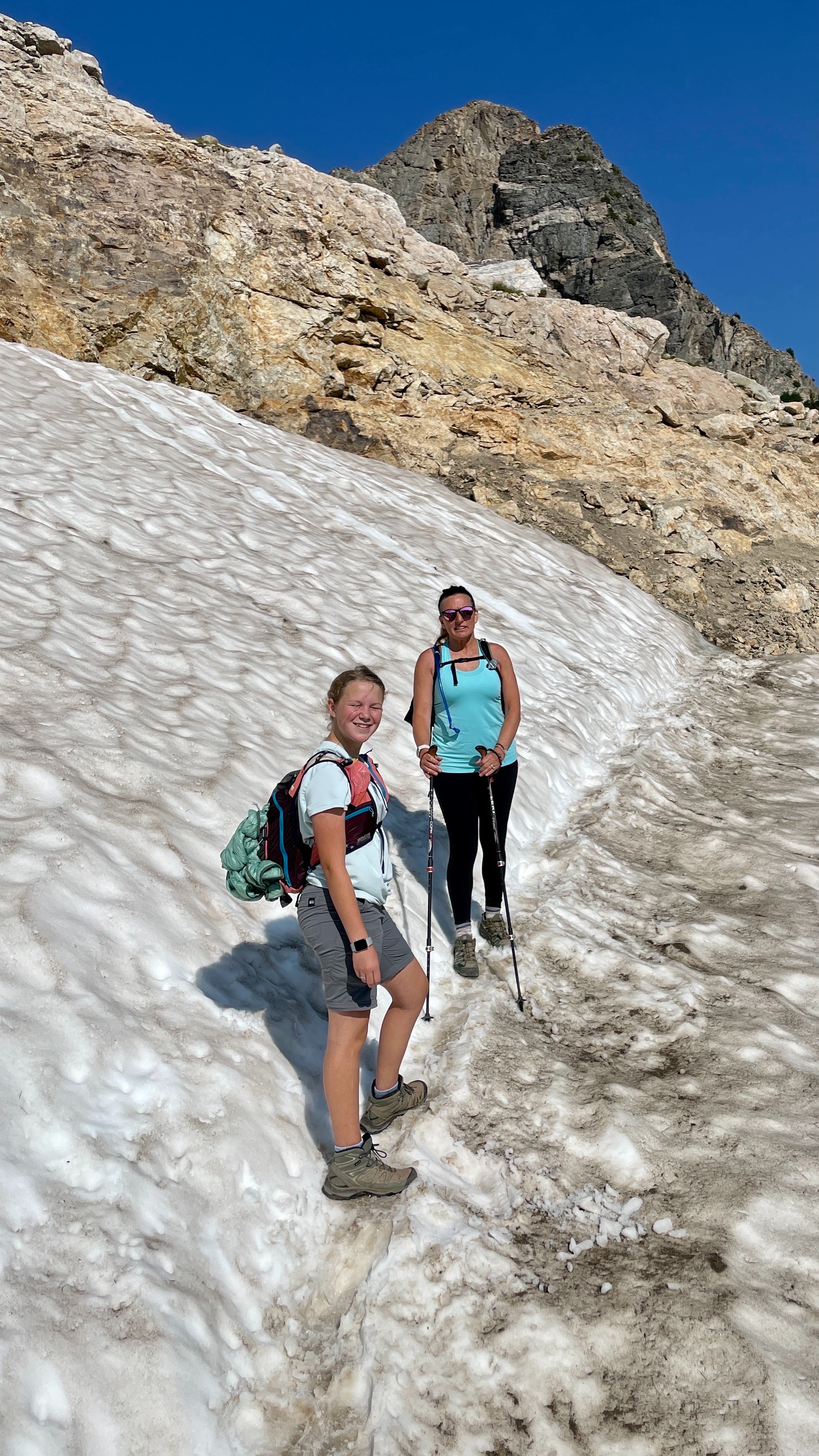 Lilya Blue and Karen Blue climb a snowy trail.