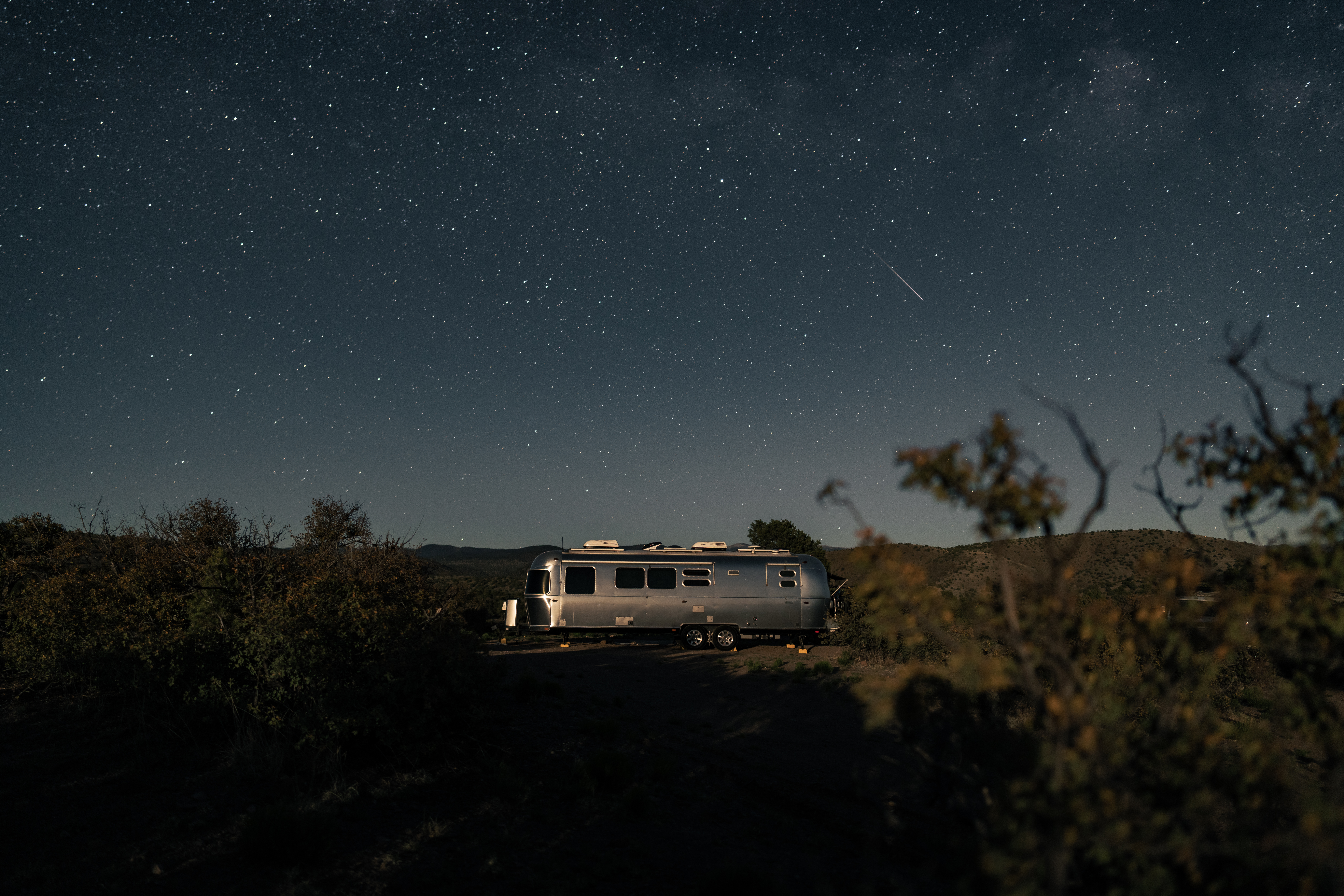 Karen Blue's Airstream Flying Cloud travel trailer at night.