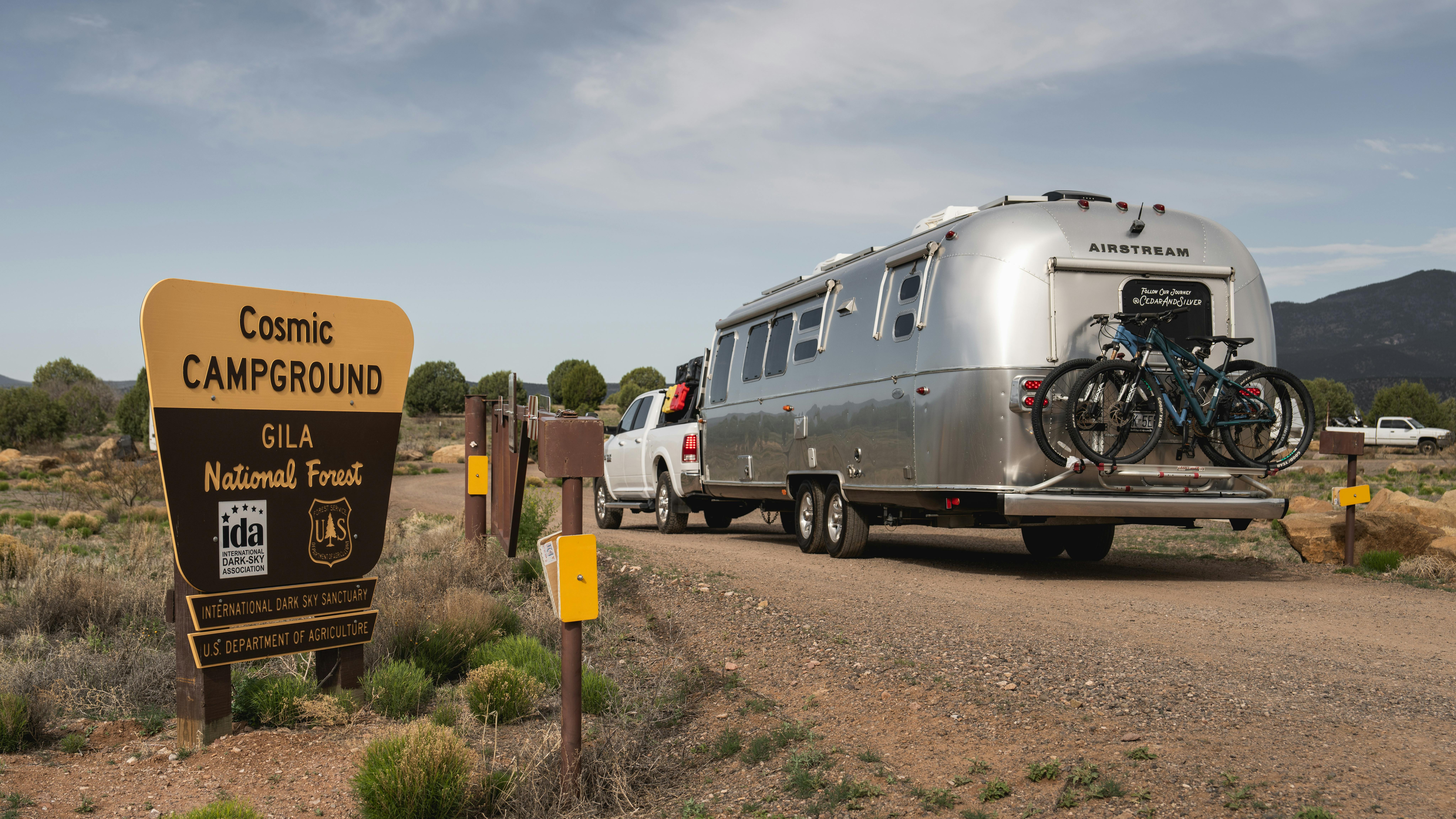 The Gila National Forest sign and Karen Blue's Airstream Flying Cloud travel trailer.