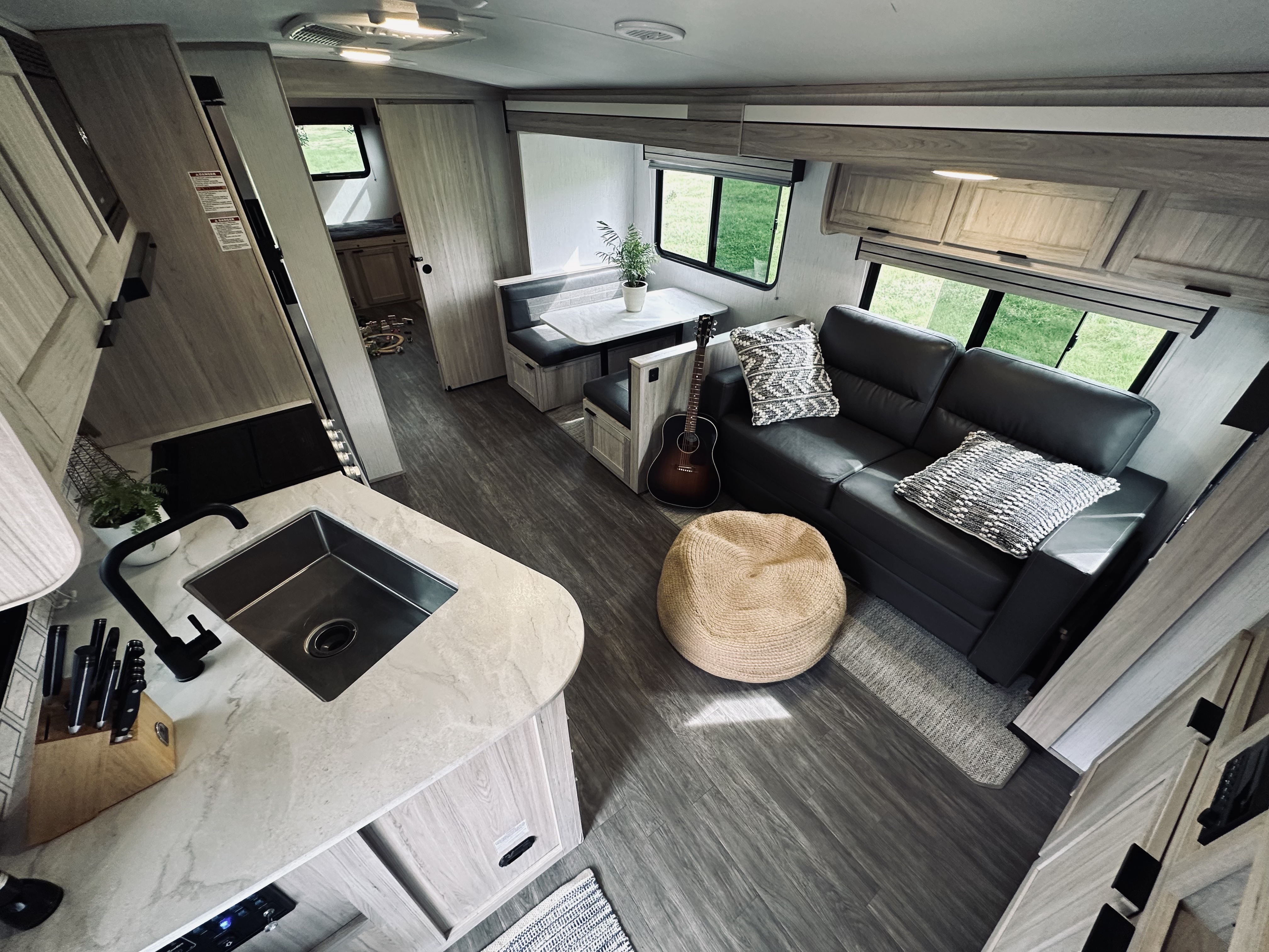 The kitchen, couch, and dinette inside John King's Shadow Cruiser travel trailer.